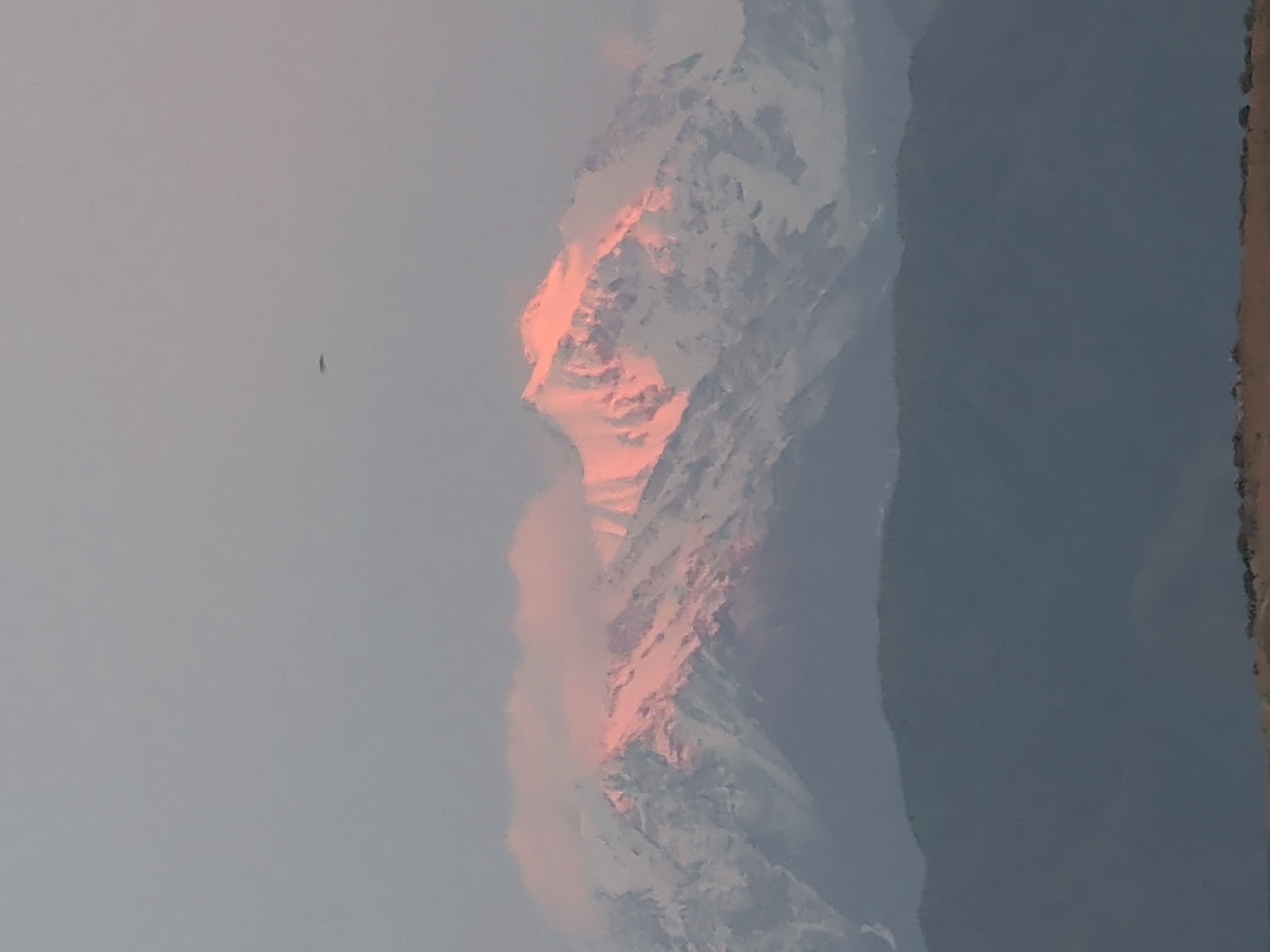 Snow-capped Tian Shan peaks glow at sunset near Bishkek