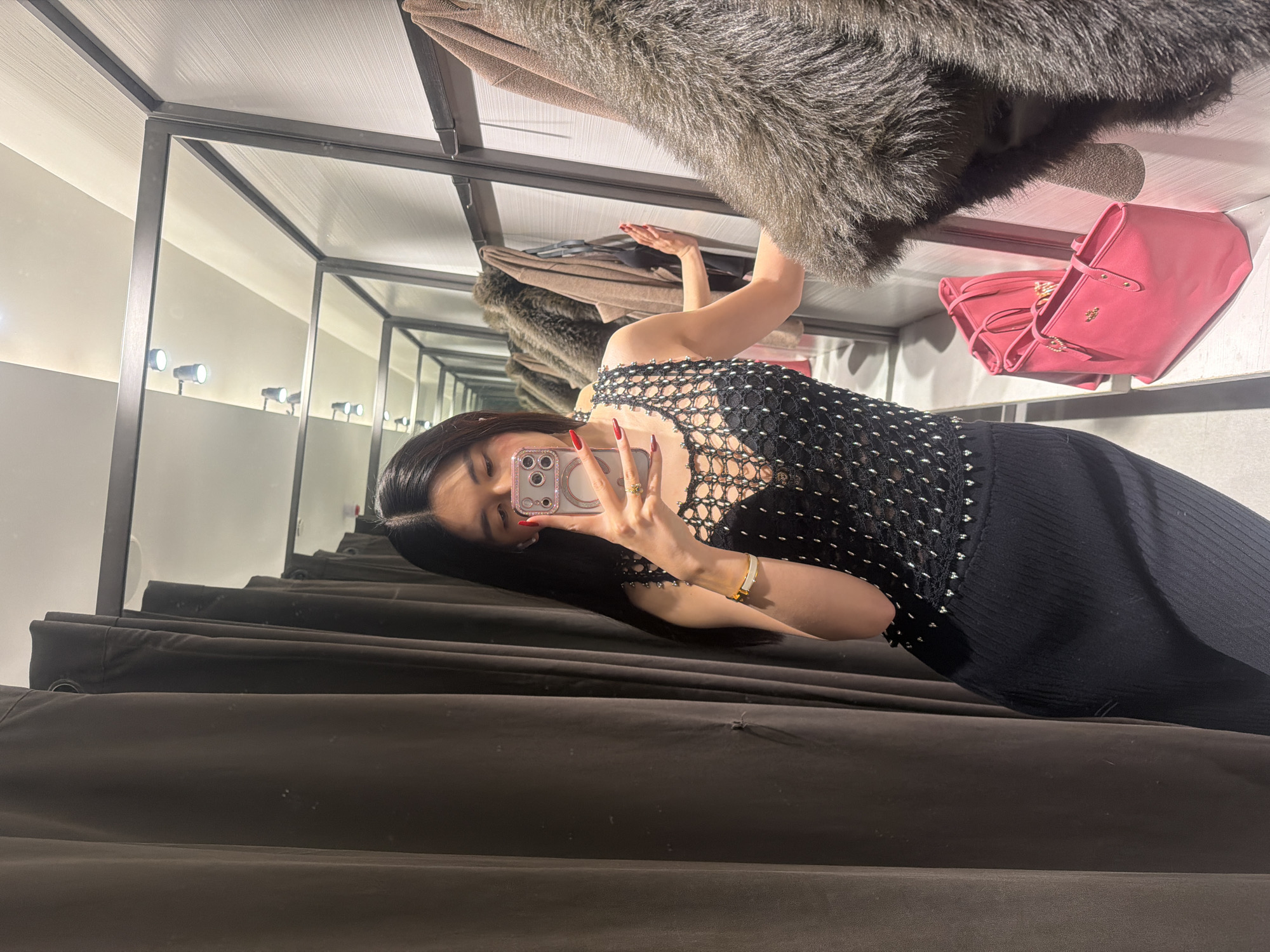 Woman takes selfie in Paris clothing store dressing room