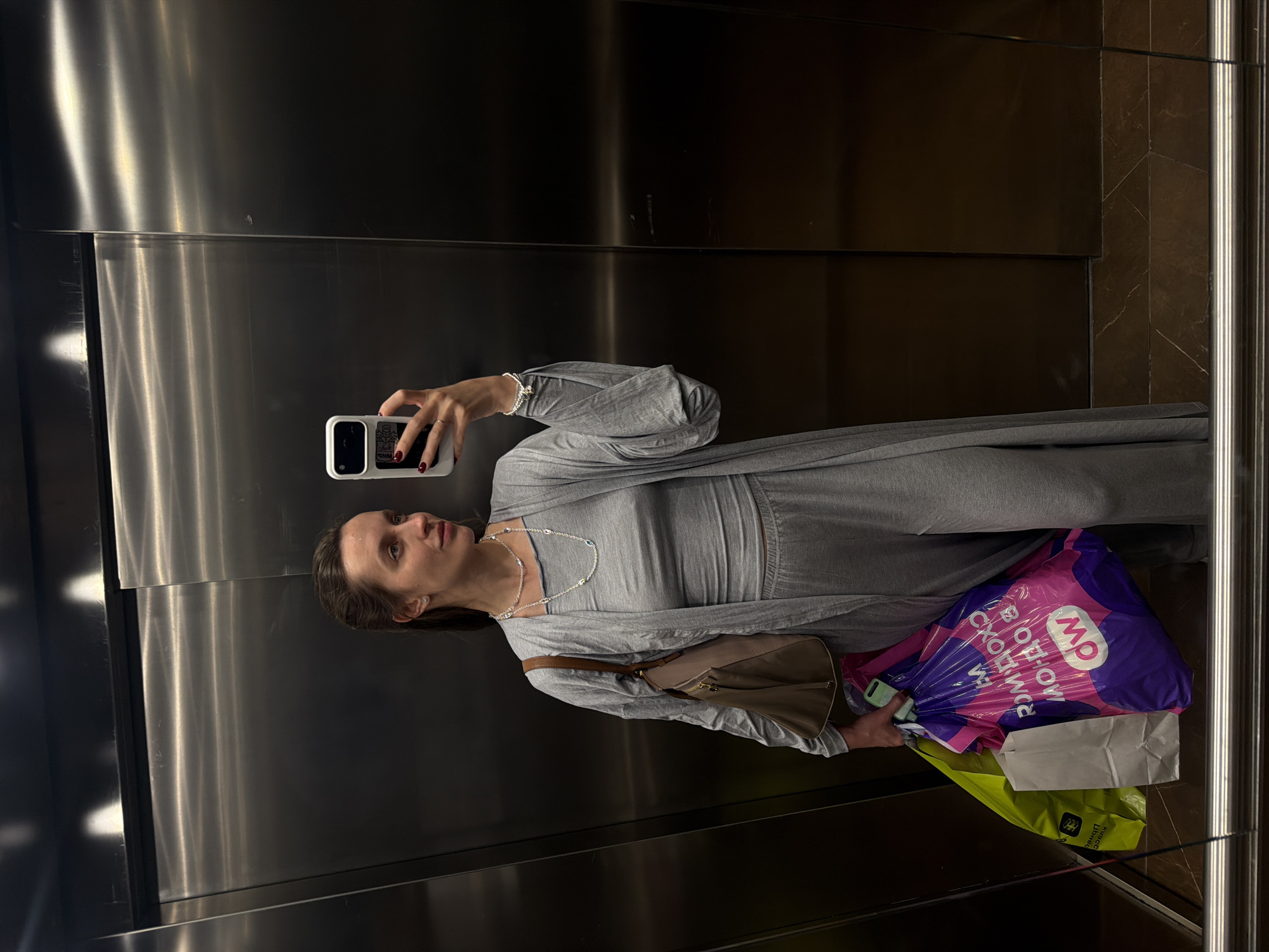 Woman takes elevator selfie while shopping in Moscow
