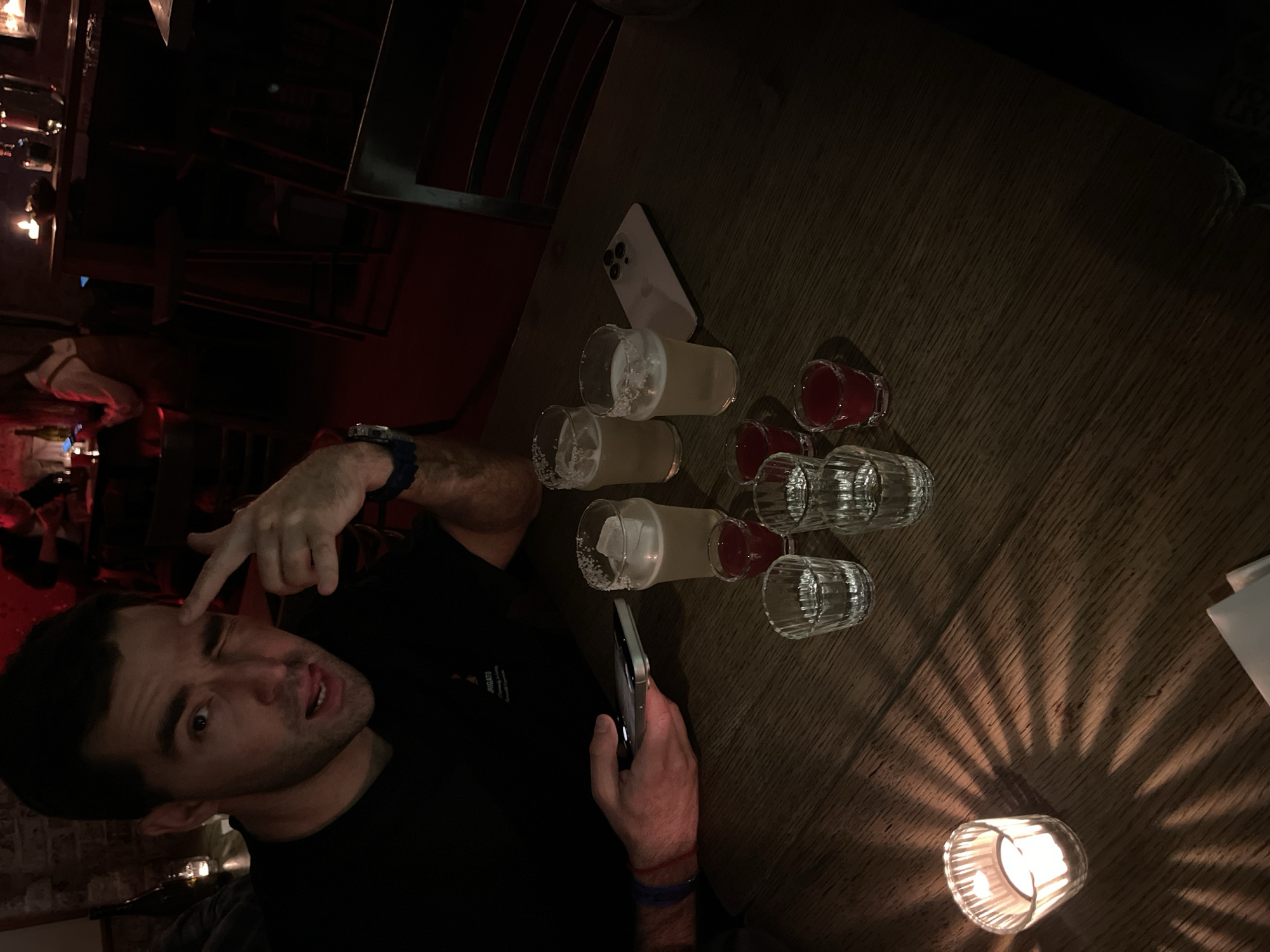 Man gestures at phone in Moscow bar