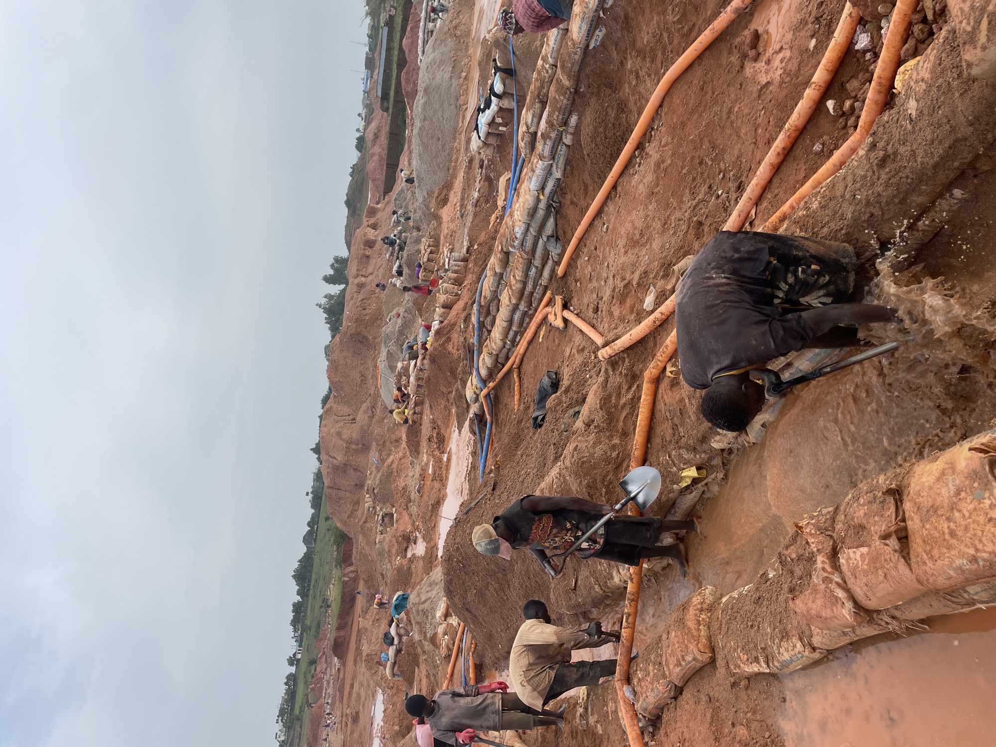 Hands-on excavation work at a muddy Rayfield, Nigeria dig site