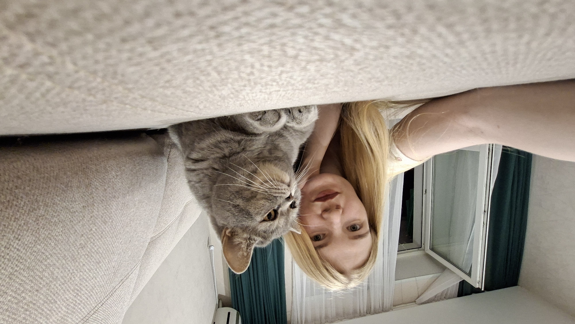 Woman documents indoor moments with cat in Chaikovsky, Russia