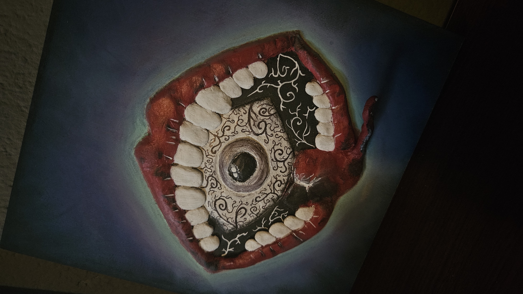 Dark artwork and novelty items photographed up close.