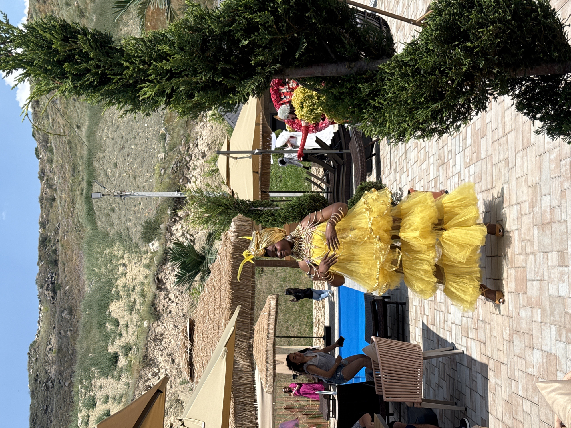 Elaborately costumed gathering at an outdoor venue in Ptghni