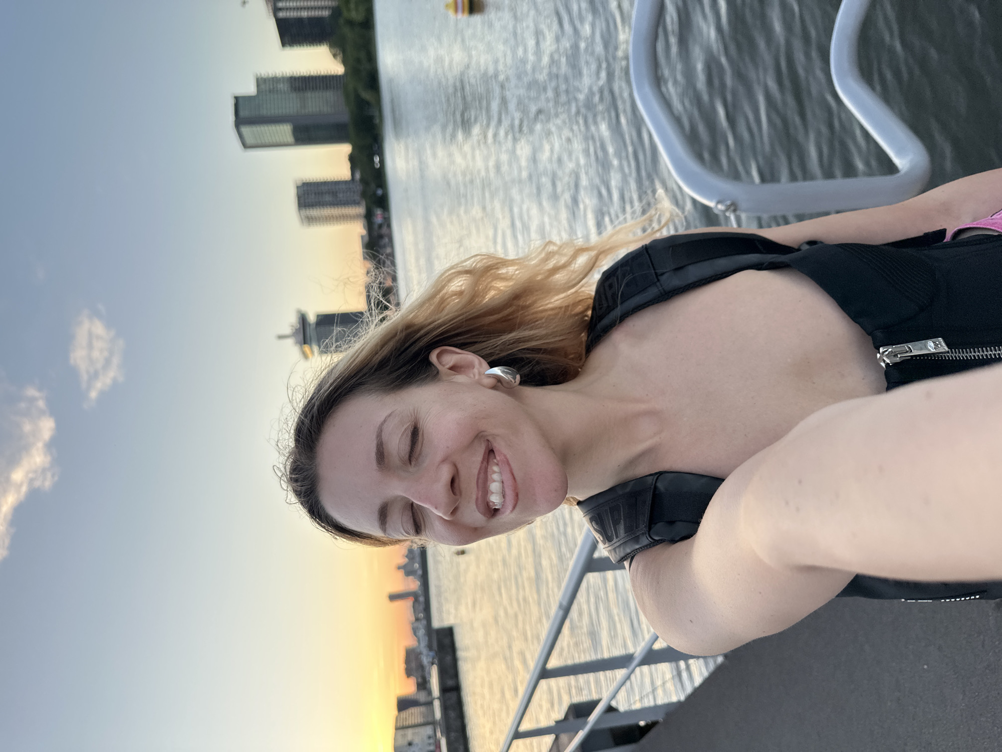 Amsterdam waterfront at golden hour, barges and people soaking it in