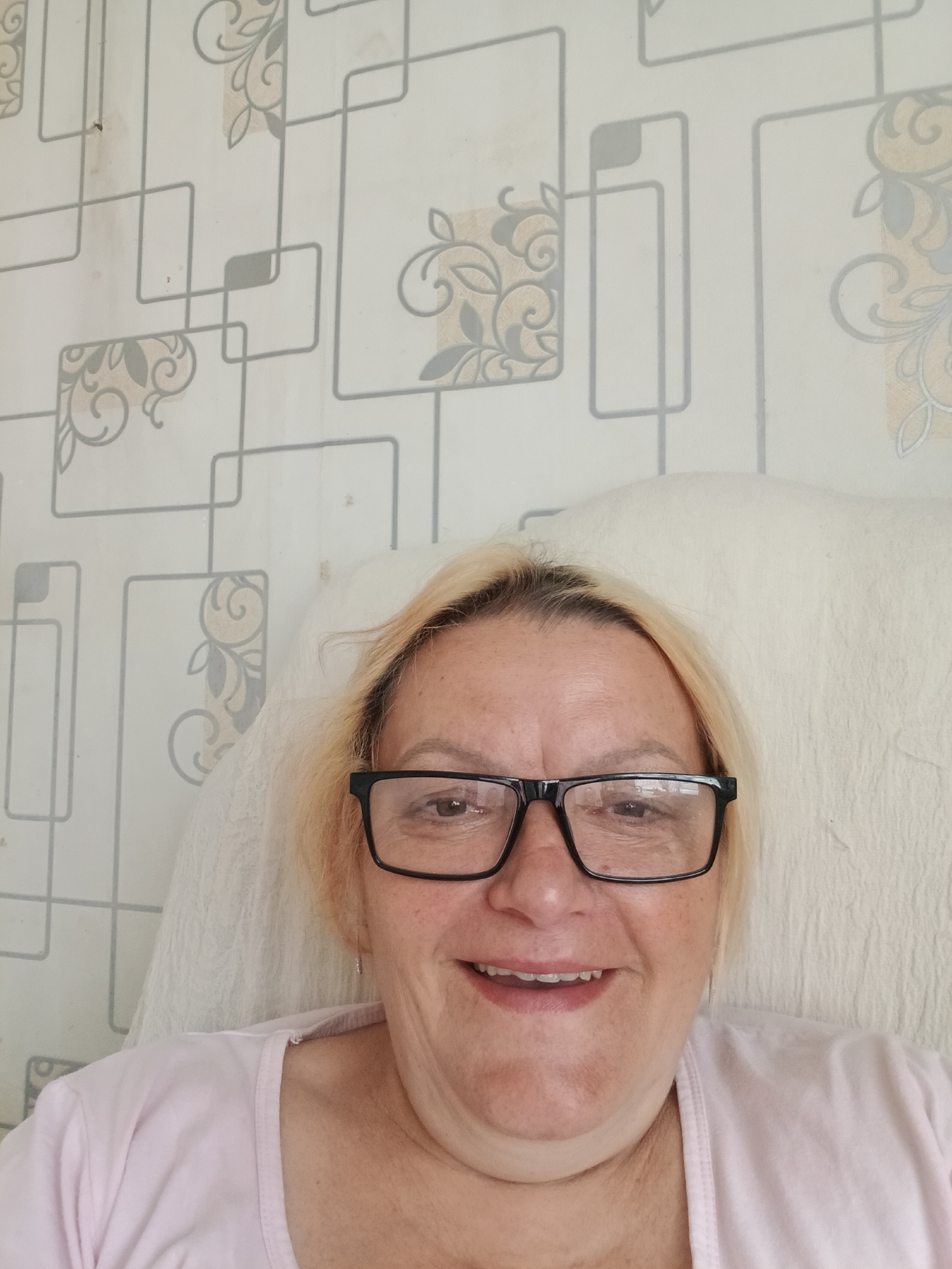 Woman takes selfies on white cushion in Красный Маяк