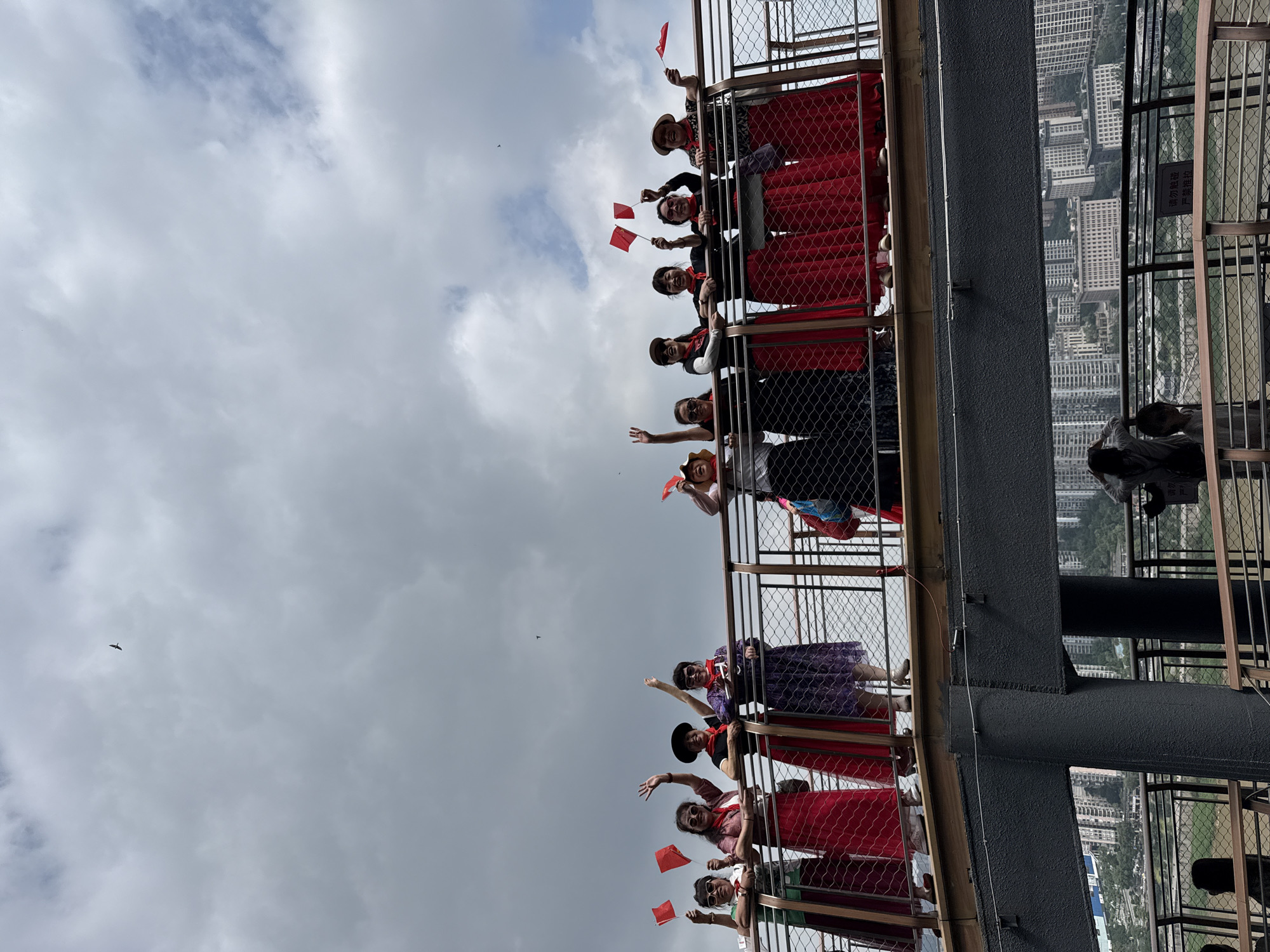 Women with flags gather on observation deck in Yuzhong