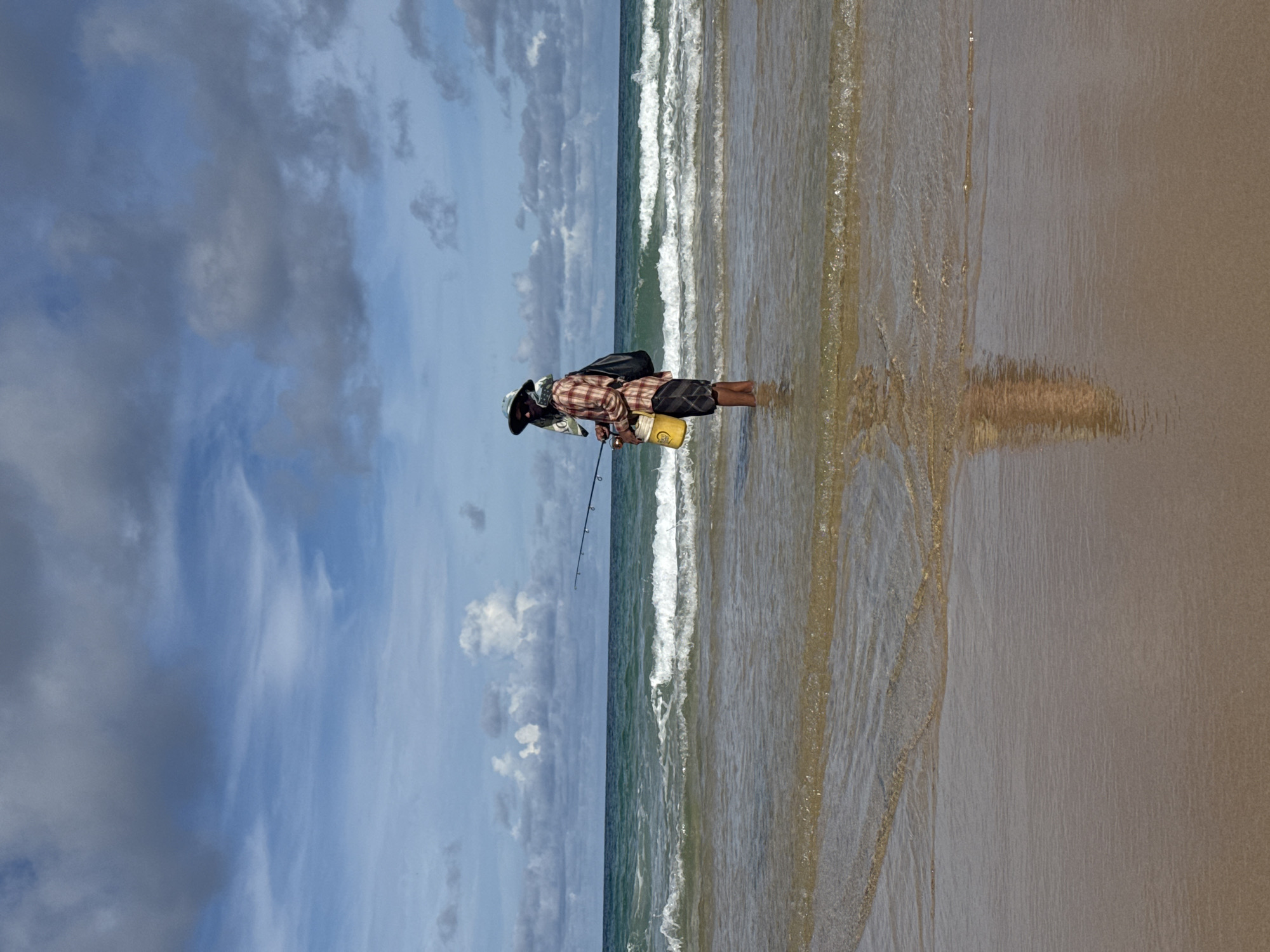 Dogs, flags, and a fisherman statue on Karon Beach