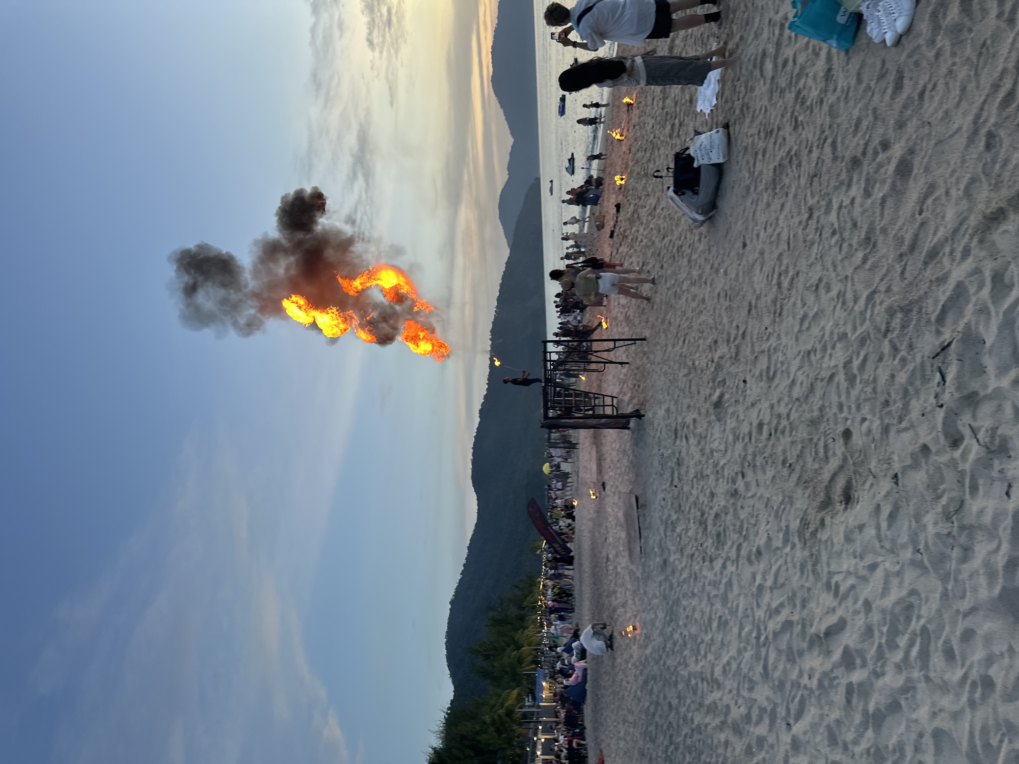 Fire performance on a George Town beach at sunset