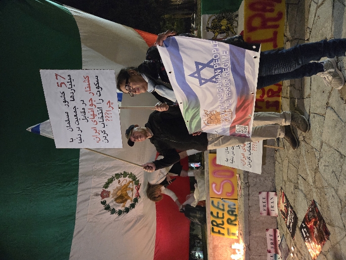 Pro-Iran freedom protesters gather in Holon with flags, candles