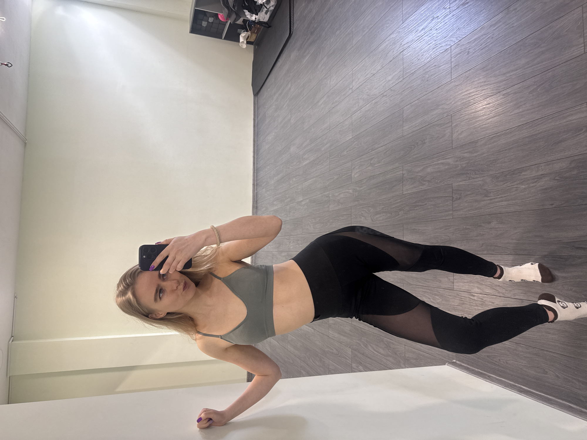 Woman Takes Mirror Selfies in Athletic Wear Indoors