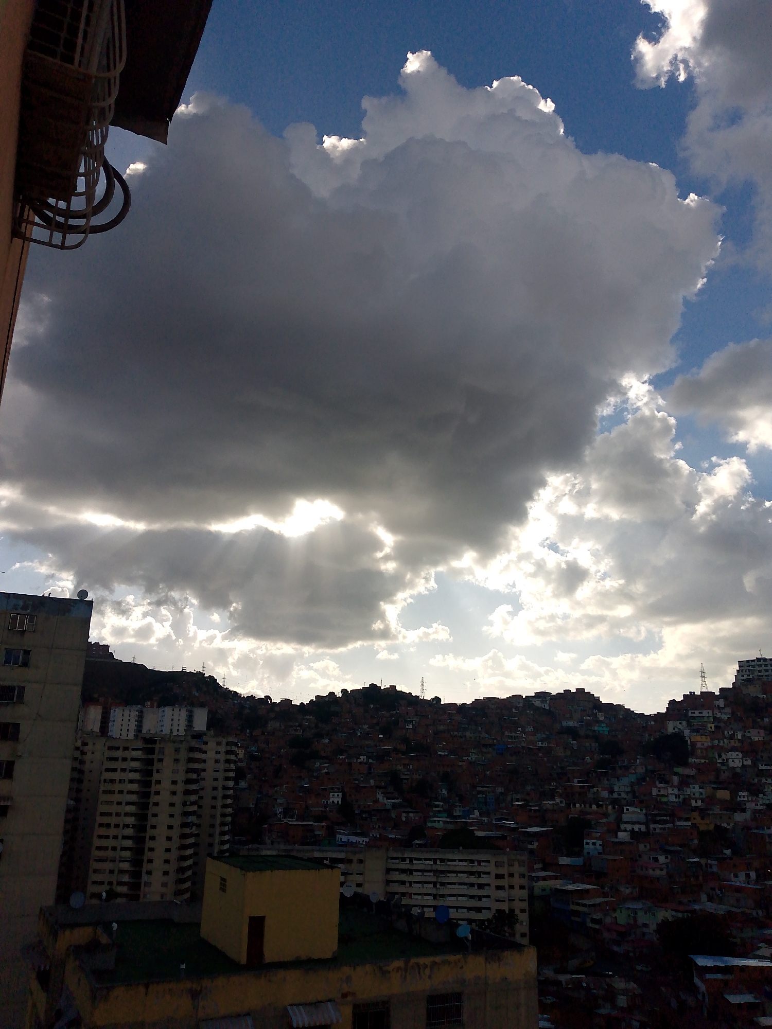 Dramatic sunset clouds captured over Caracas urban landscape