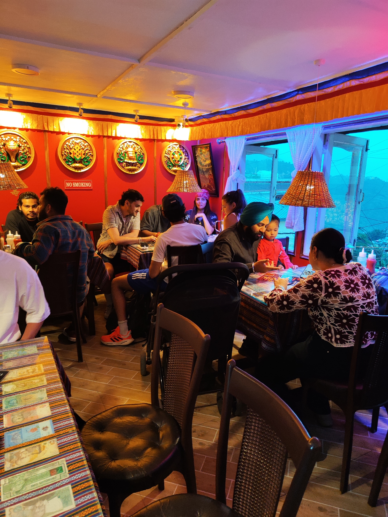 Afternoon dining scenes captured at Bhagsu restaurants with international currency