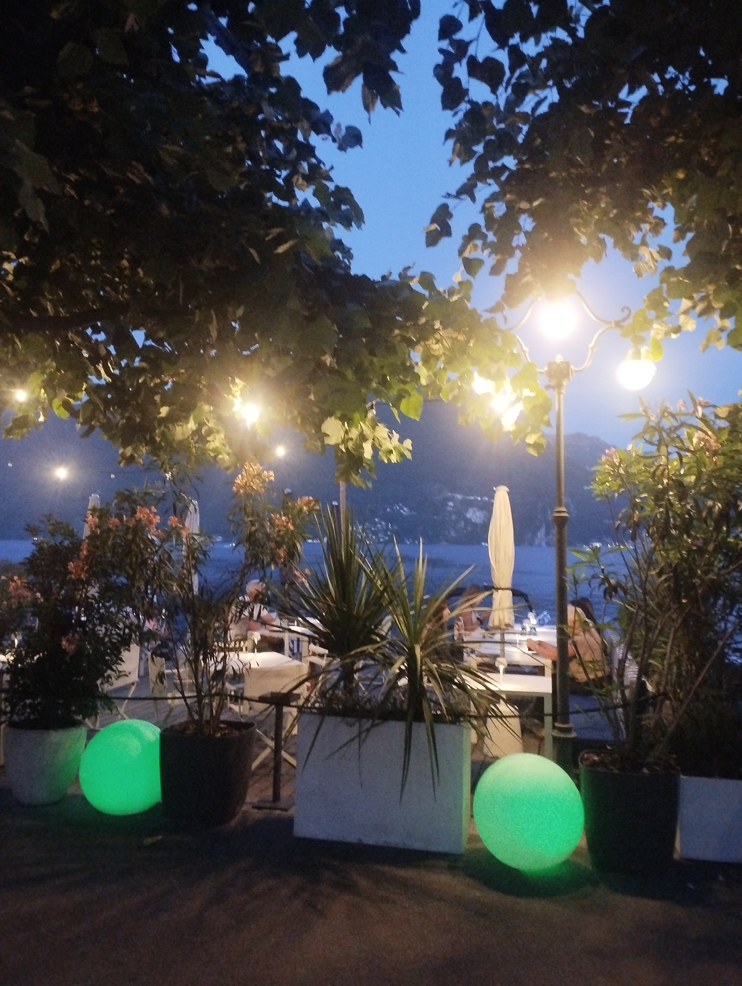 Summer evening stroll through illuminated Lugano during Swiss celebration