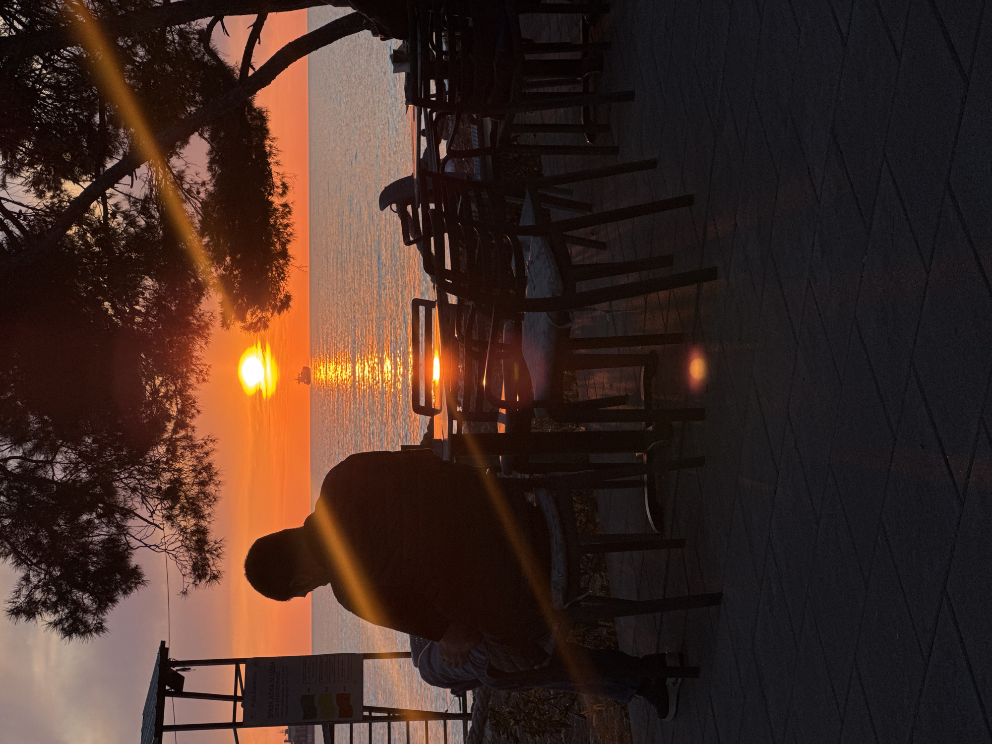 Person watches sunset over Adriatic Sea in Bar, Montenegro