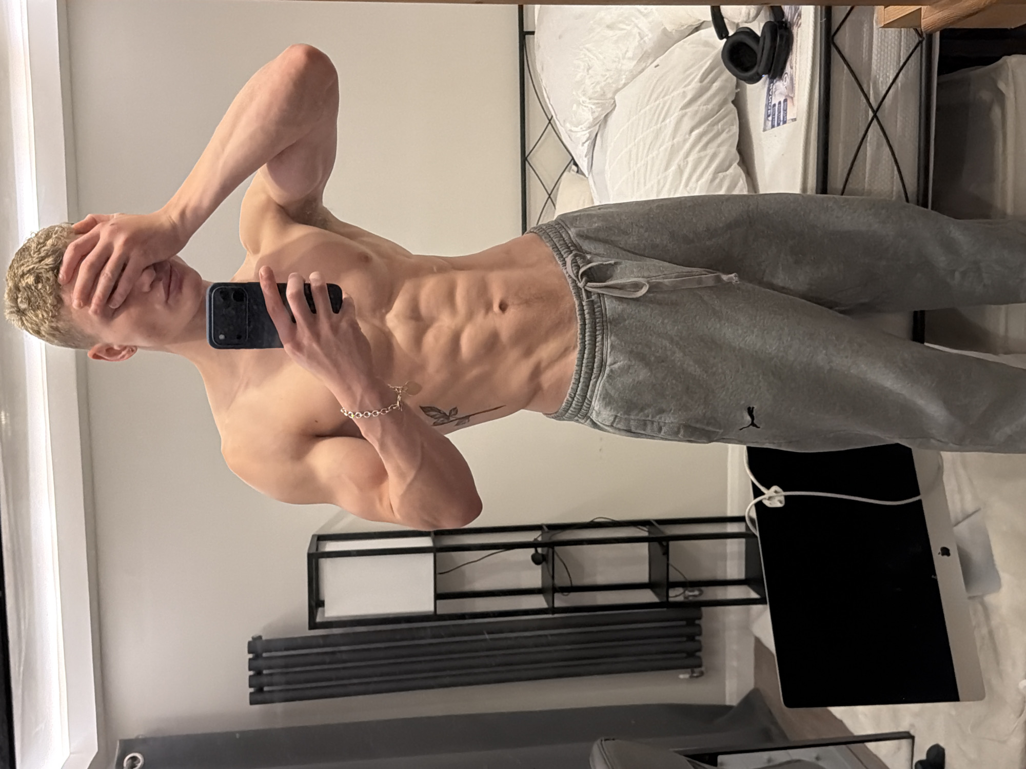 Man with smartphone observed in London bedroom setting