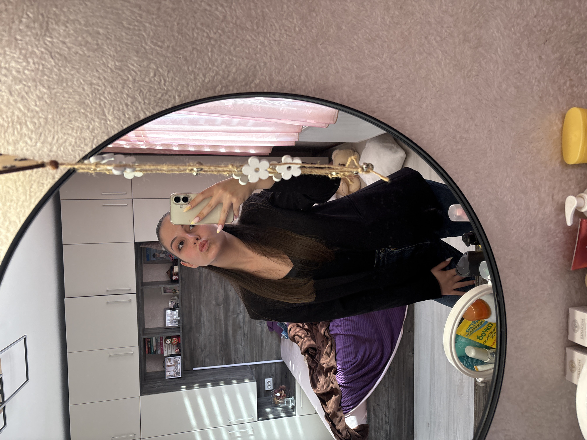 Woman takes mirror selfies in Bulgarovo bedroom early morning