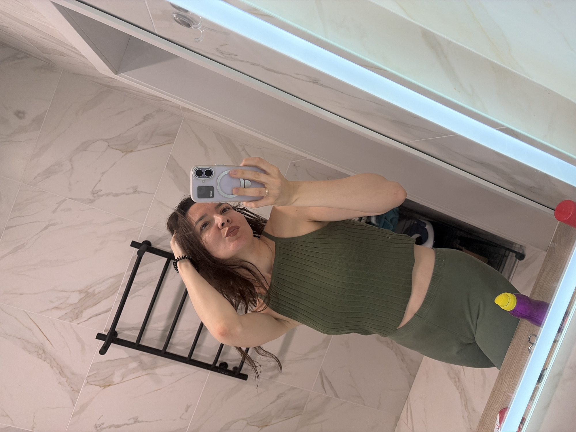 Mirror selfie in a green ribbed matching set.
