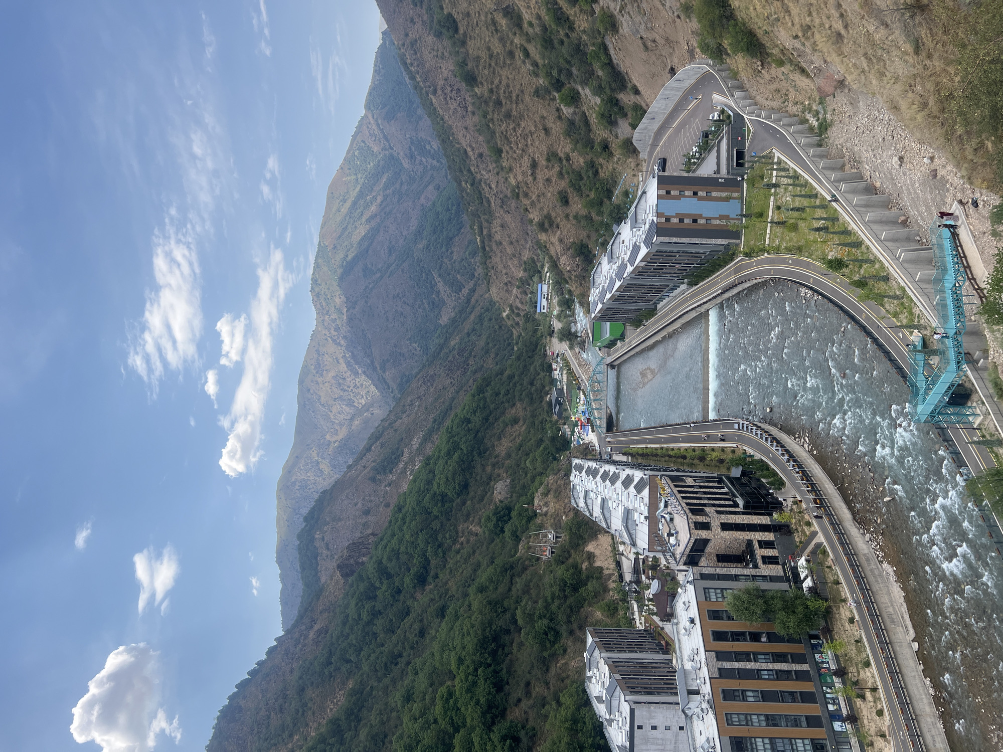 Khumsan valley views: riverside city, lookout platform, and mountain bridge