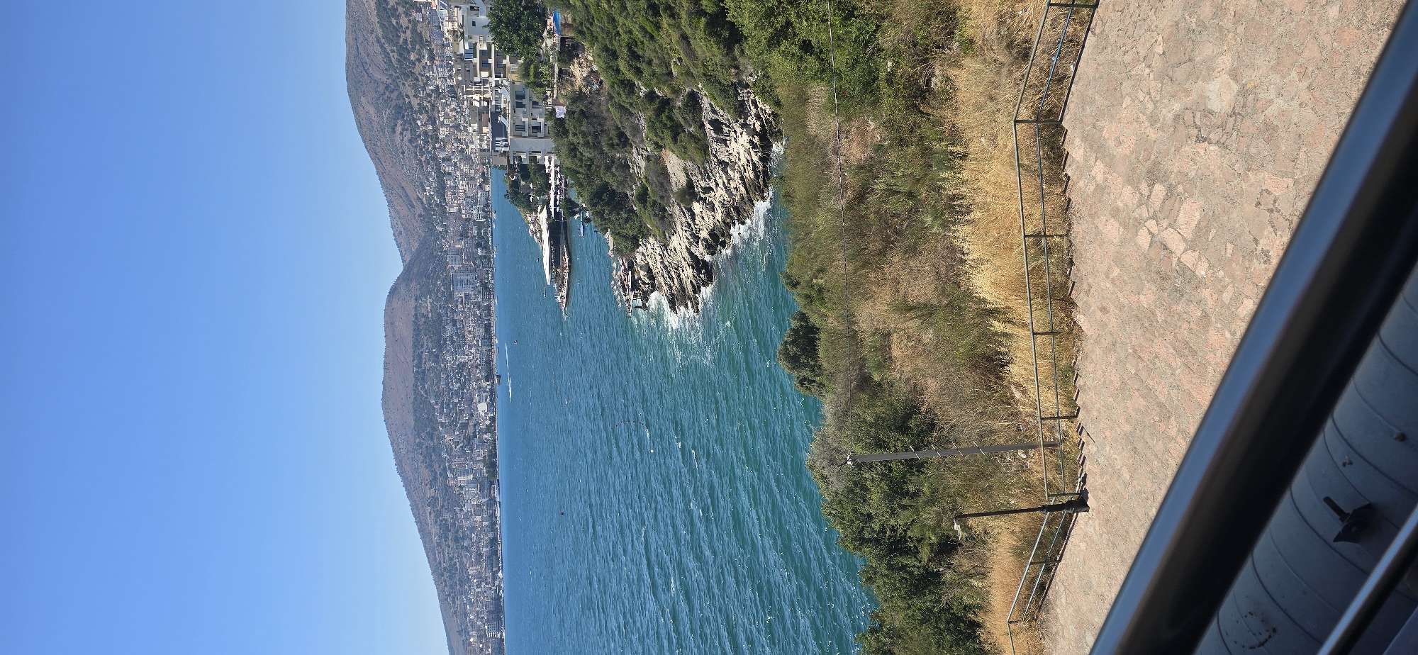 Saranda's coastline and hillside apartments on a clear afternoon