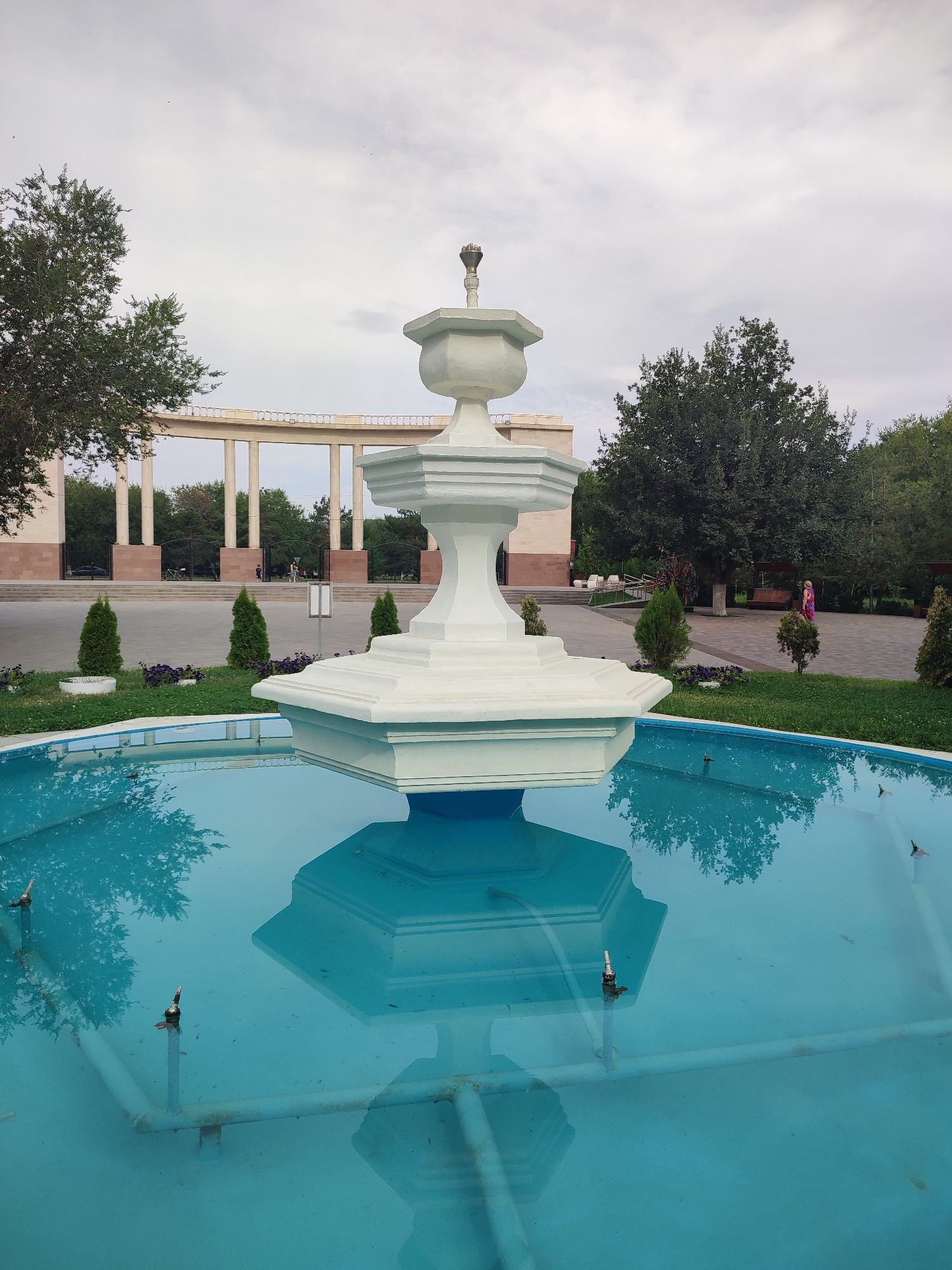 Ornate fountain and gold sculpture in a Qonaev park