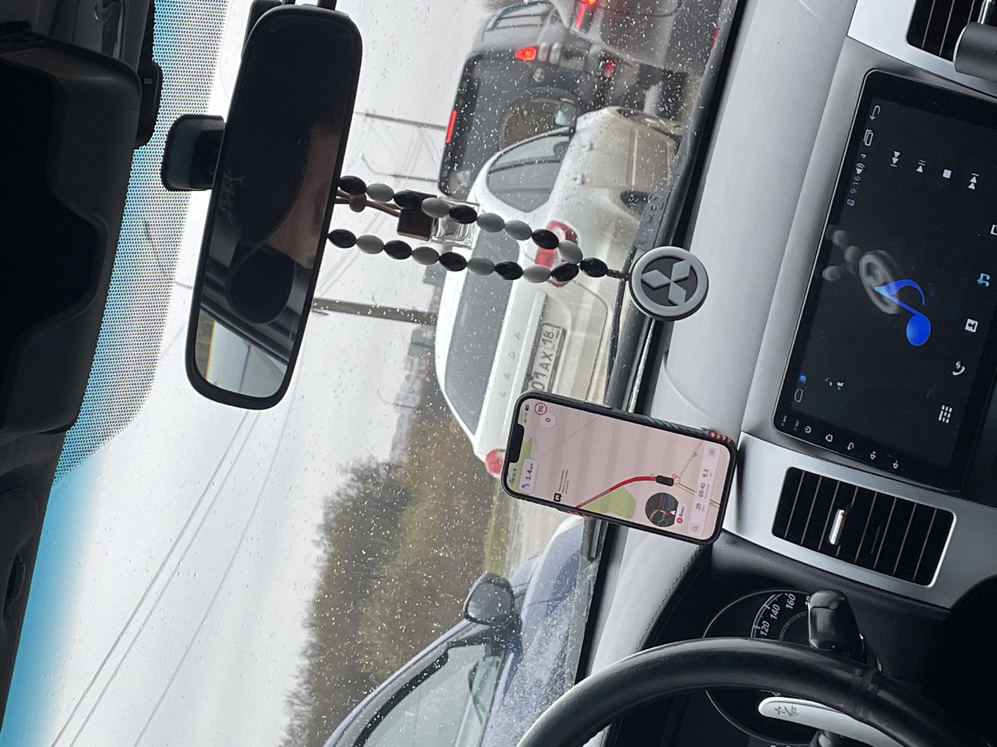 Driver's dashboard view with mounted smartphone map in Russia