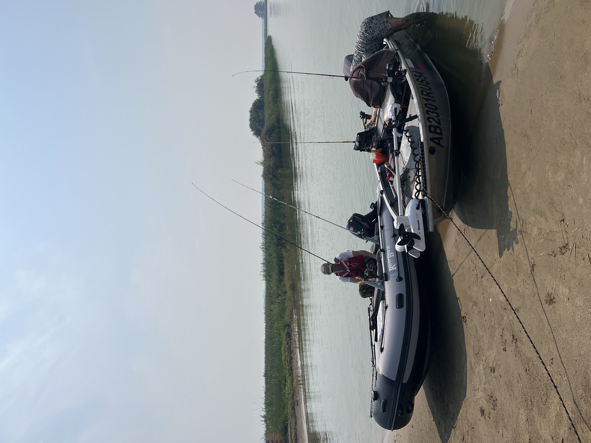 Fishing boats on the Ob River near Novopichugovo on a hazy morning