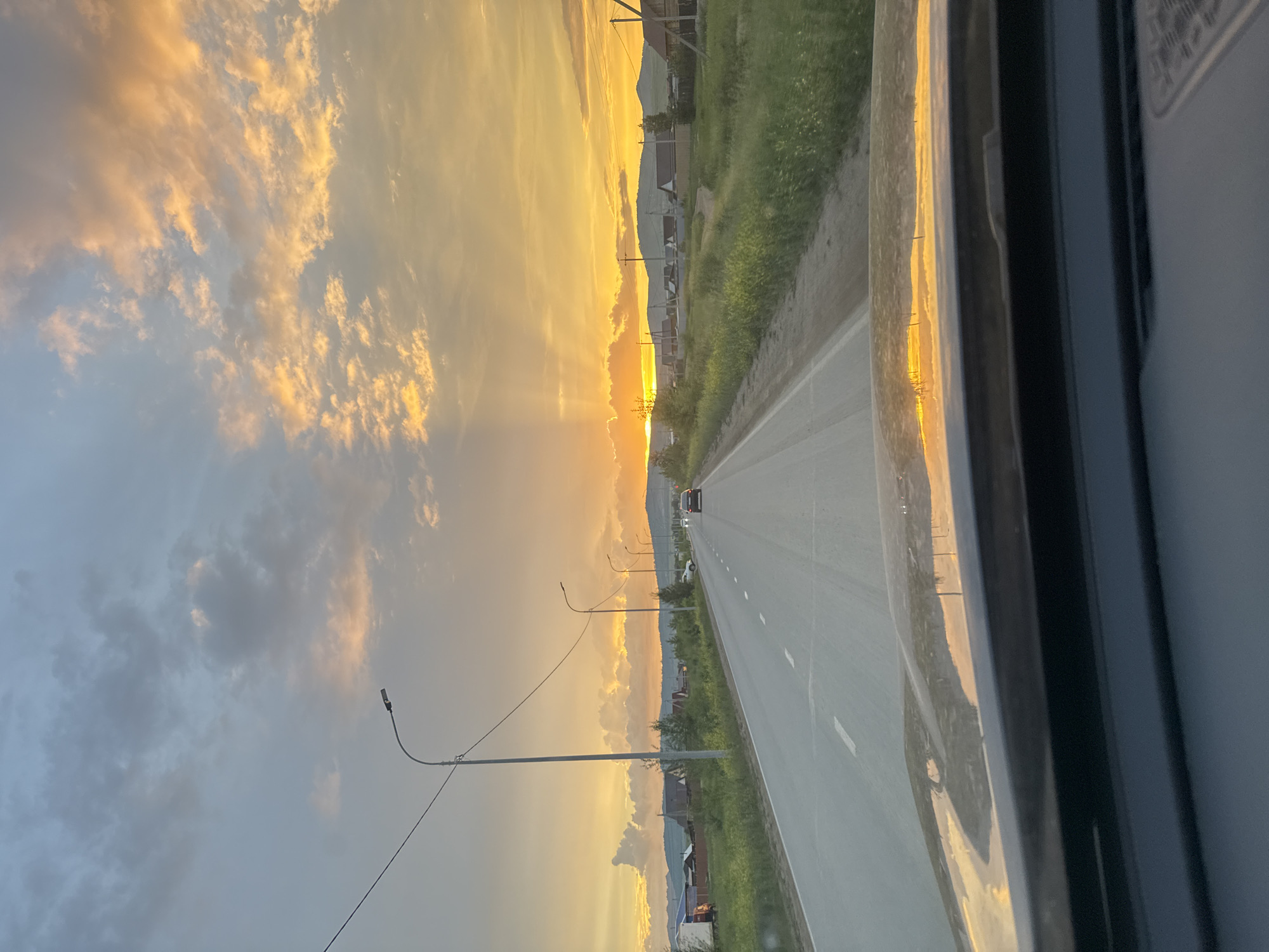 Rural road trip wraps up under a golden sunset sky