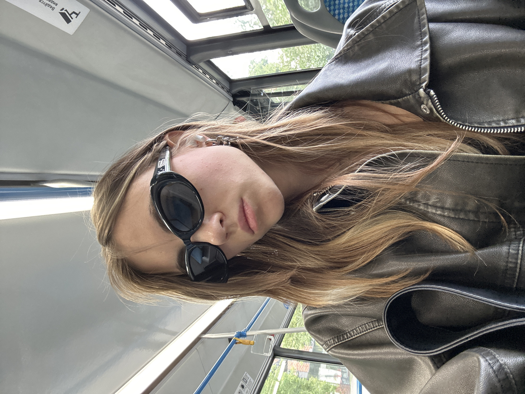Leather jacket and dark sunglasses on a Moscow bus