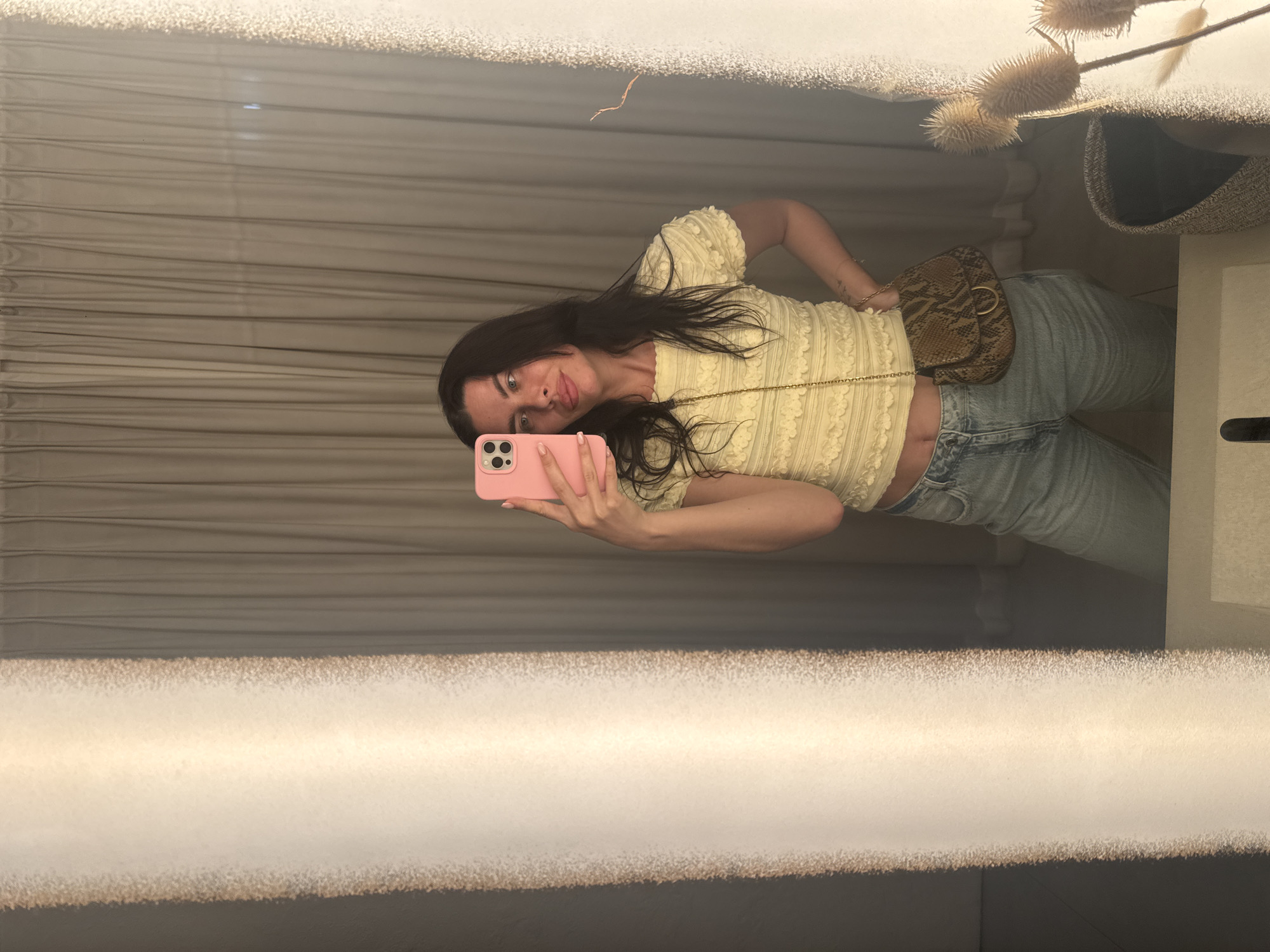 Mirror selfie in Perm hallway, yellow top and snake-print bag