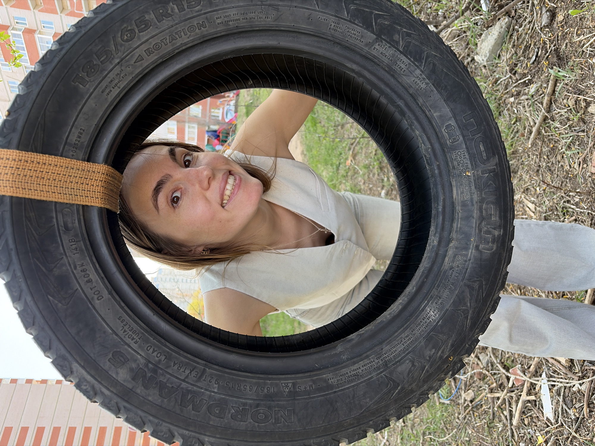 Child plays on tire swing at Izhevsk playground