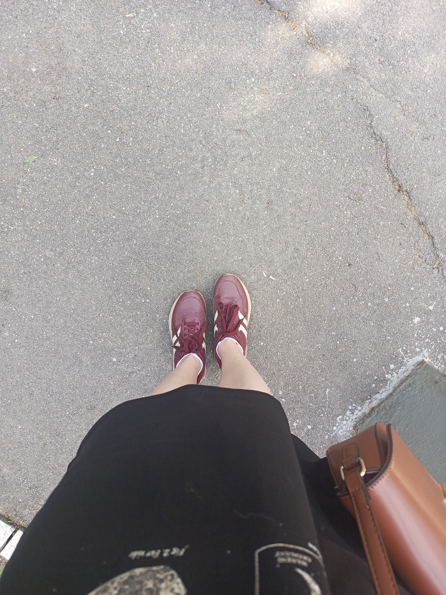 Person in maroon sneakers moves through Dedovsk street scenes