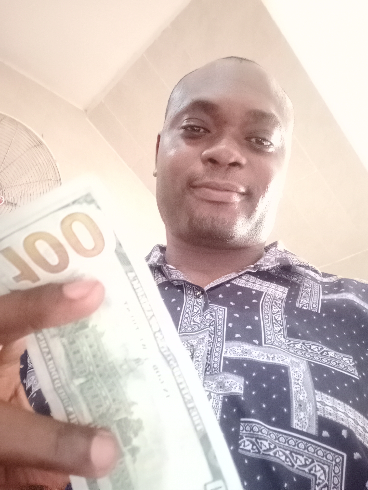 Man photographed multiple times in Gwarinpa home, dollar bill shown