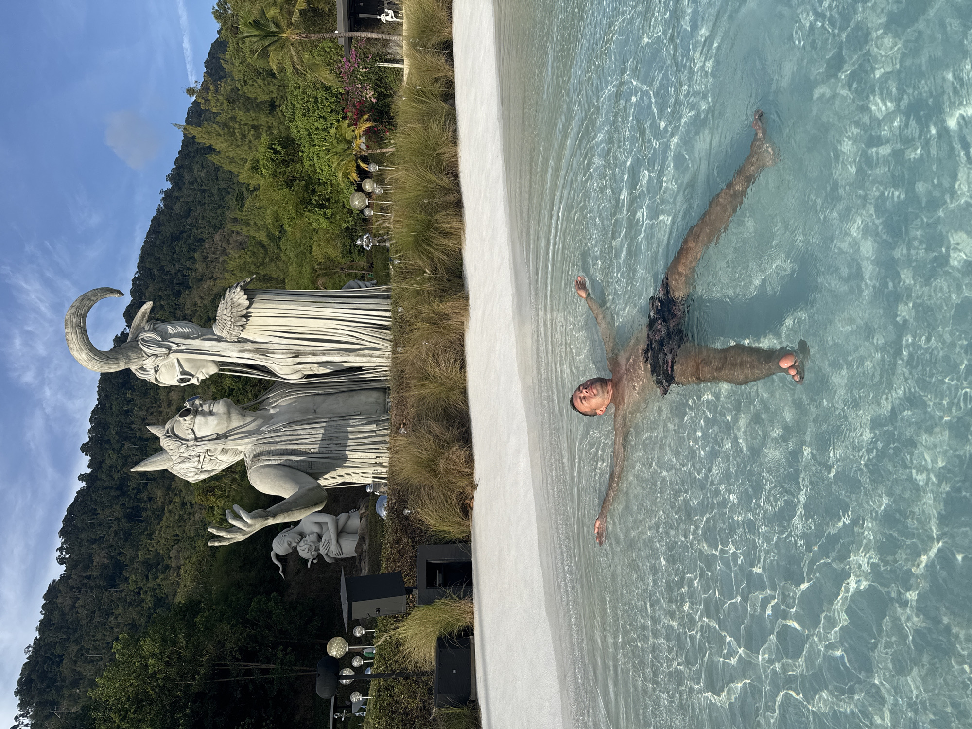 Resort guests enjoy pool, sculptures at Baan Lipa Noi facility