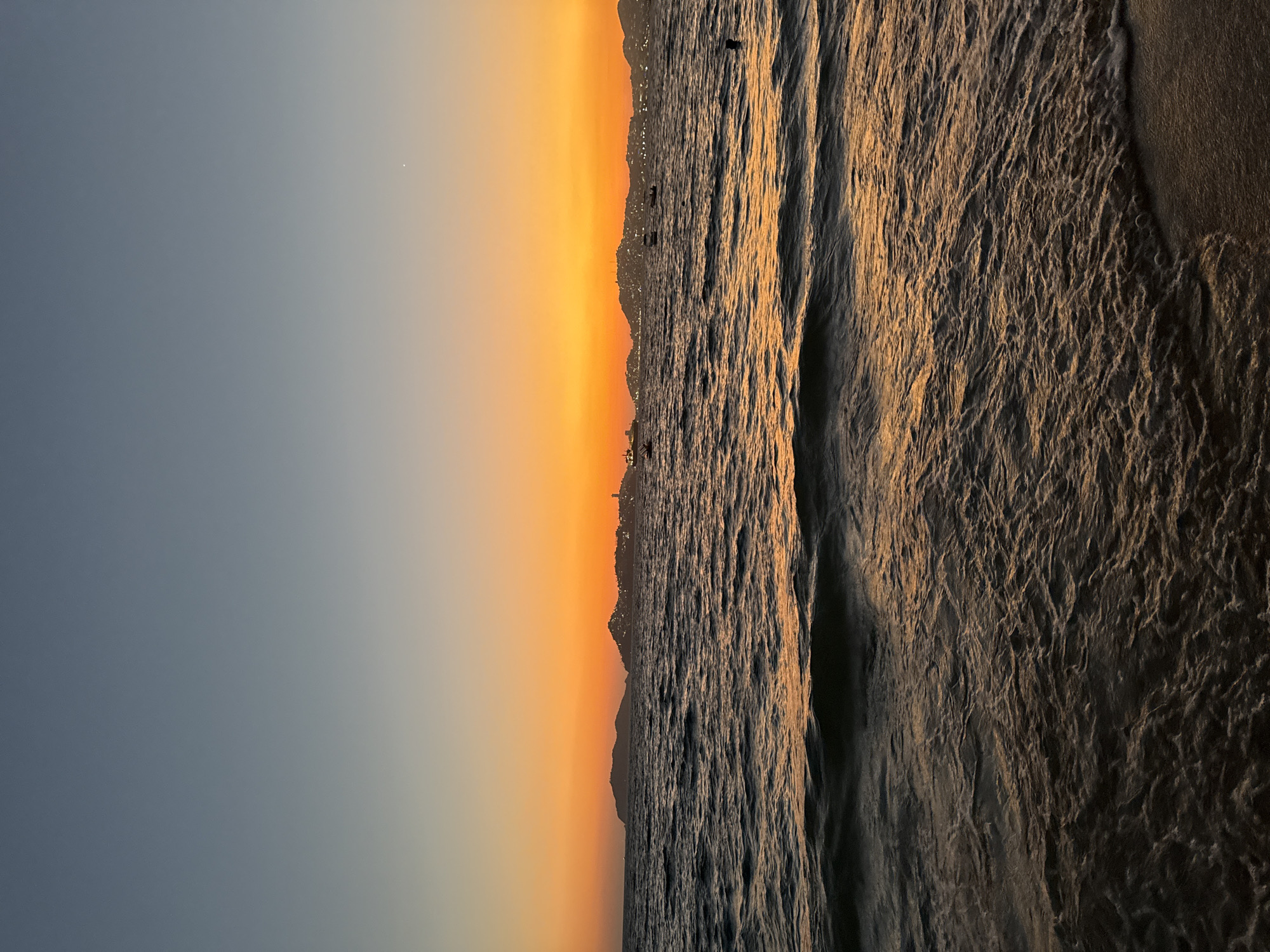 Sunset observed over Acapulco coastline with orange skies