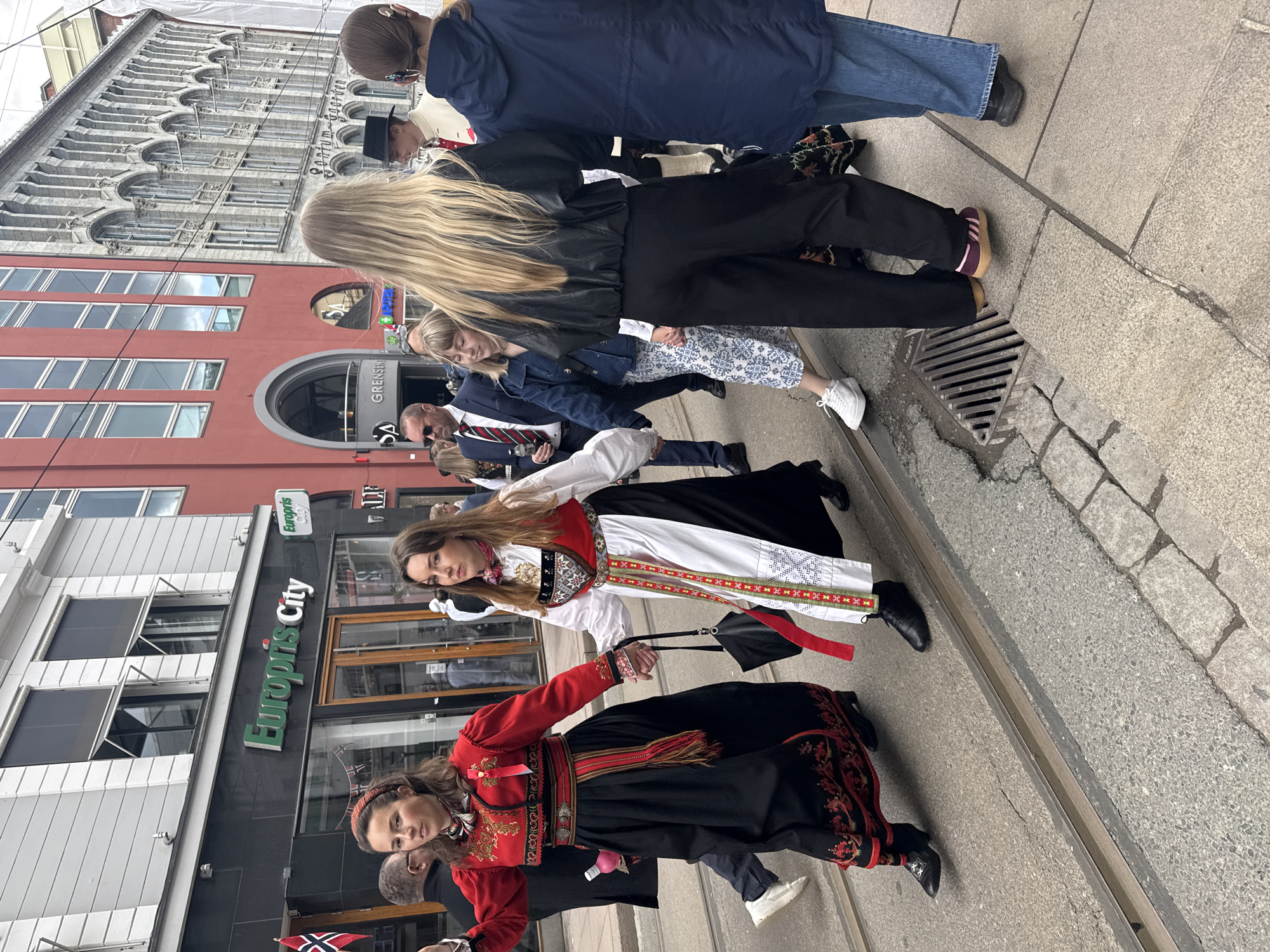 Women in traditional bunad costumes gather in Oslo streets