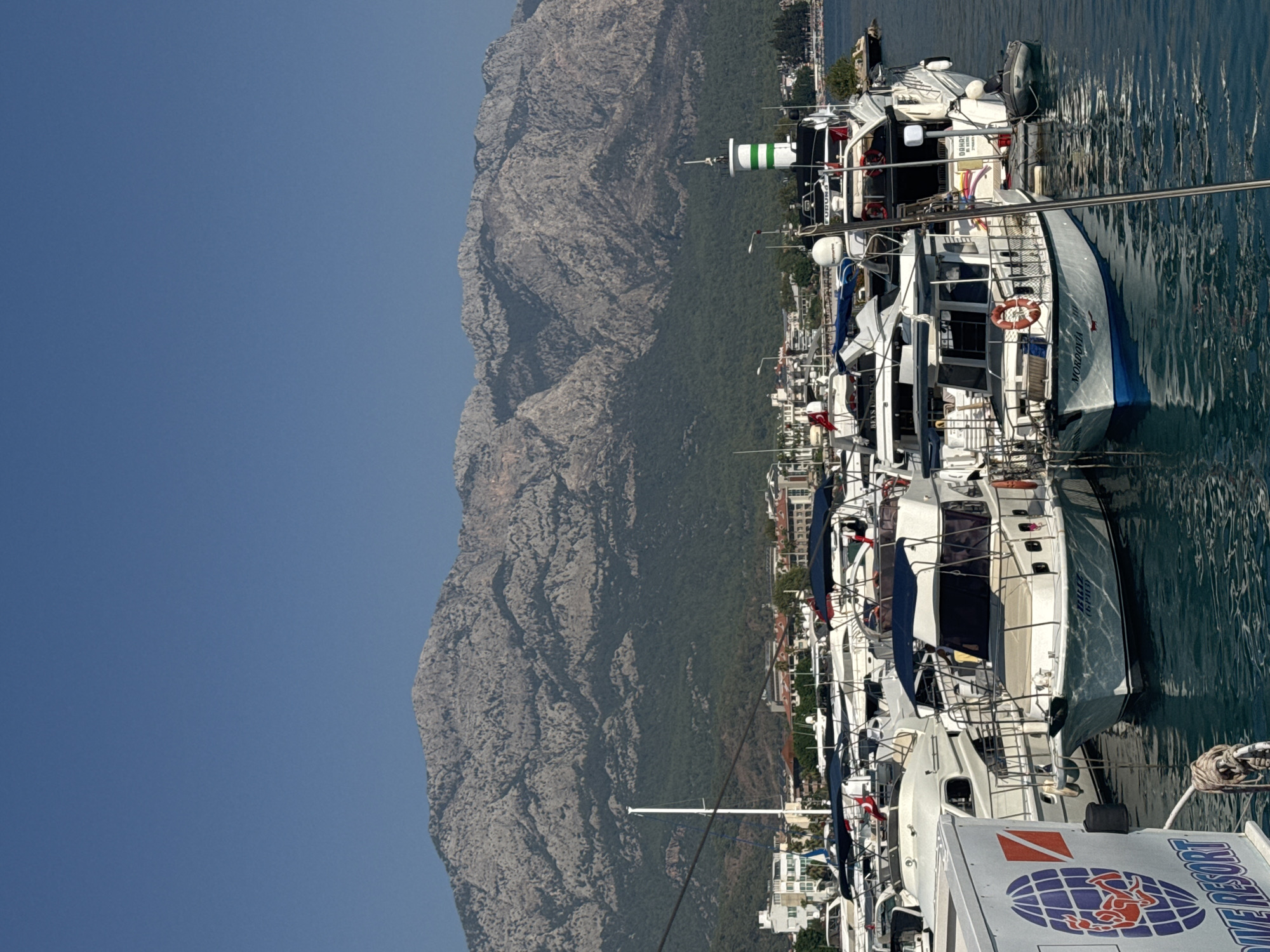 Kemer Marina on a sunny morning, boats and mountains.