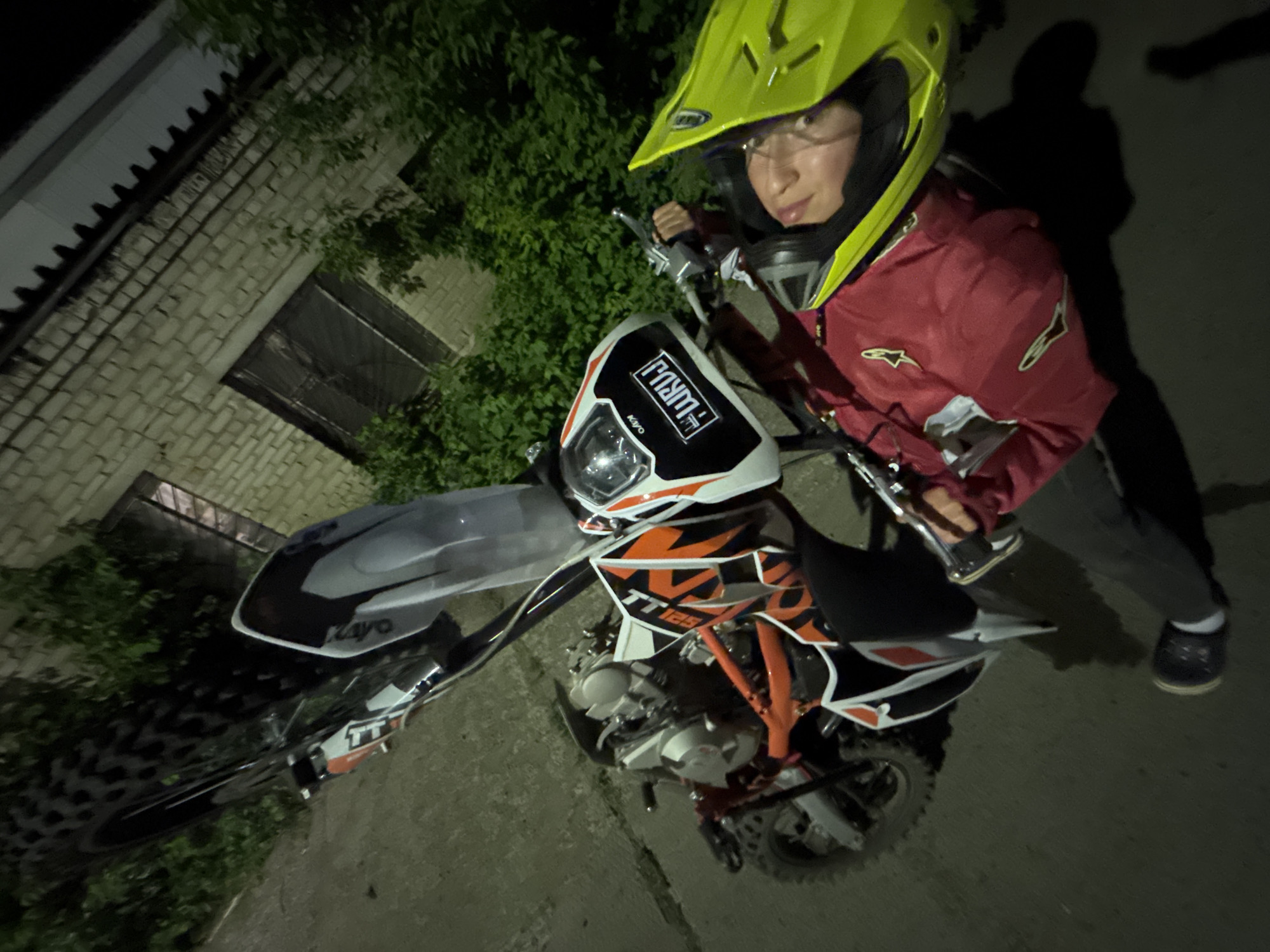 Motocross rider photographed with dirt bike during evening in Chaikovsky