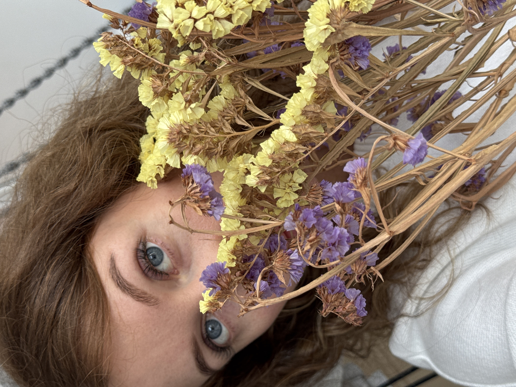 Woman arranges dried flower bouquet in Chaikovsky, Russia