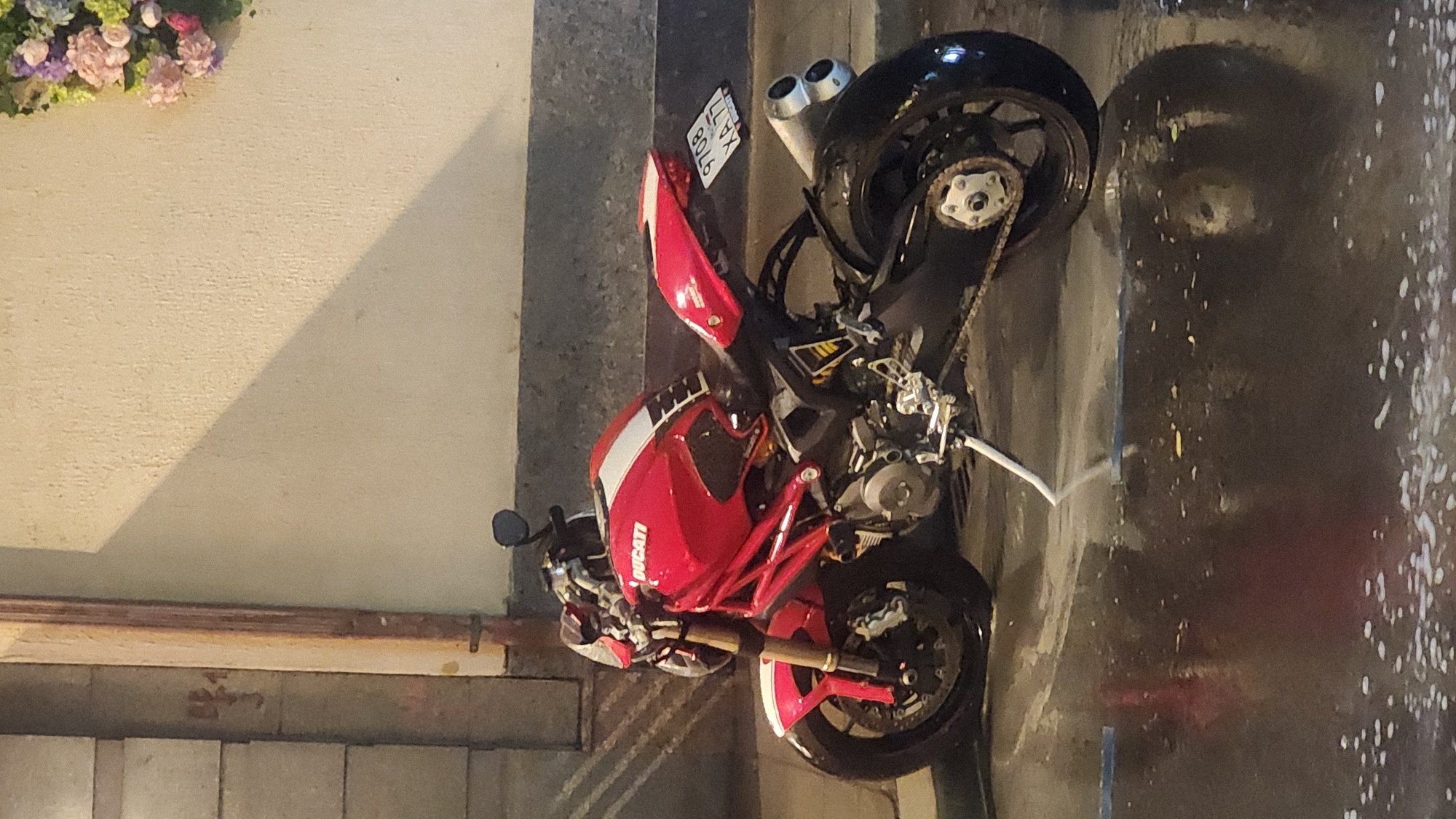 Red Ducati motorcycle spotted parked on wet Moscow street
