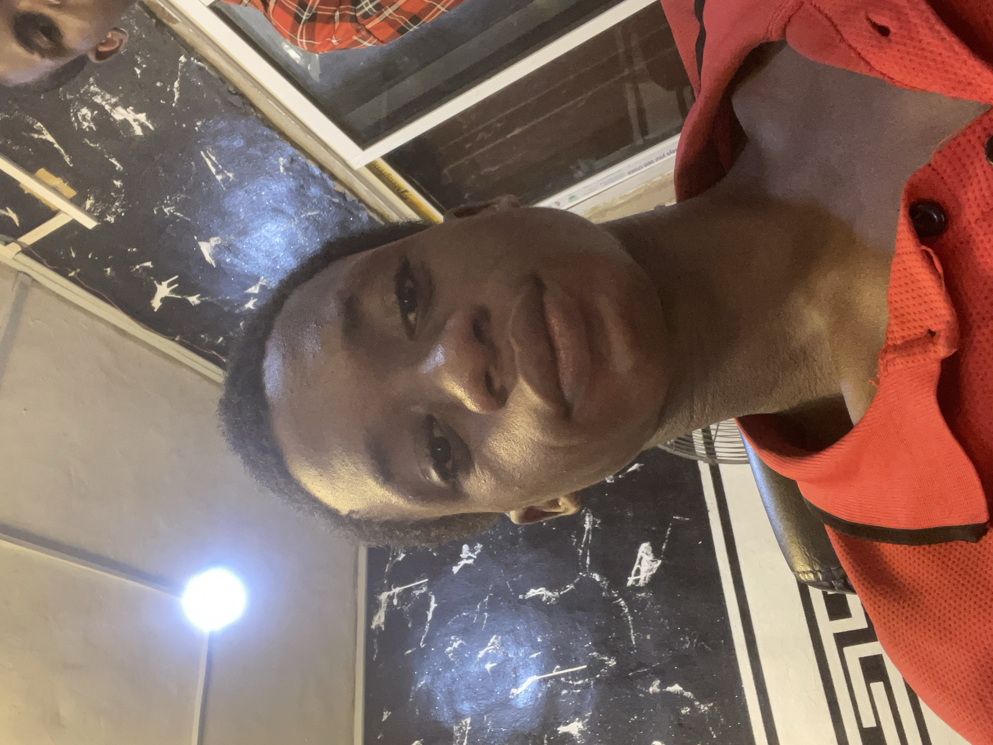 Young man takes selfies at Onitsha barbershop