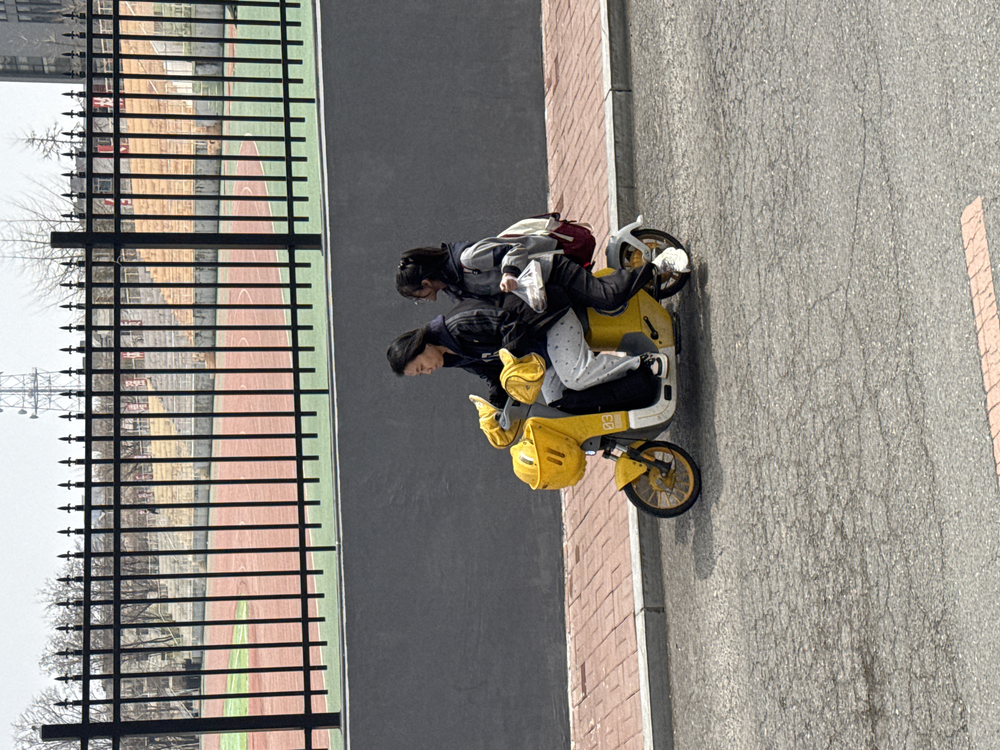 Young people gather with yellow electric scooter in Zhongtun