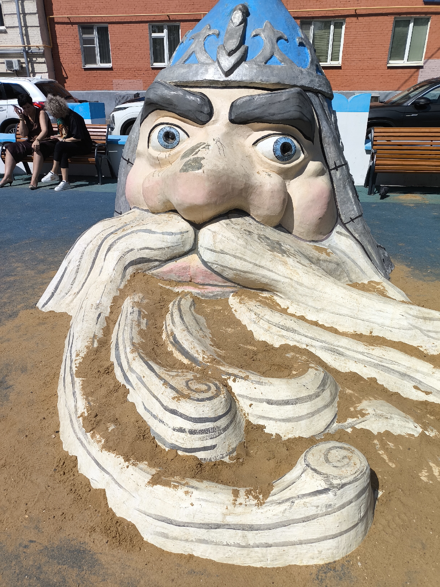 Urban park features artistic sculptures and castle playground entrance