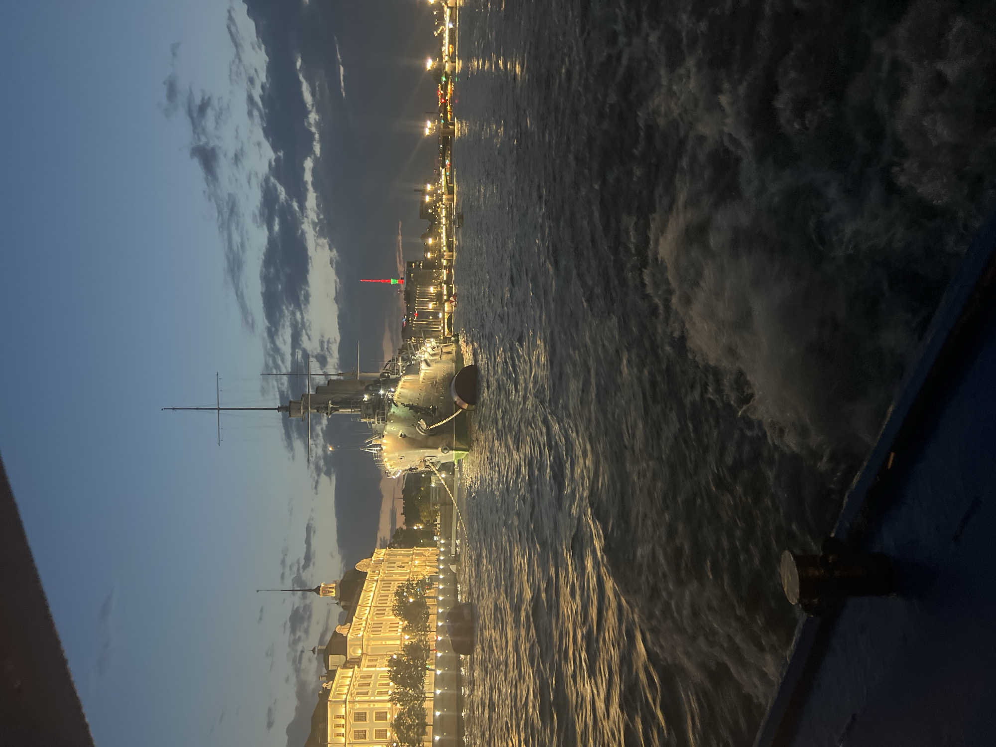 Evening cruise past the Aurora and Saint Petersburg's lit waterfront