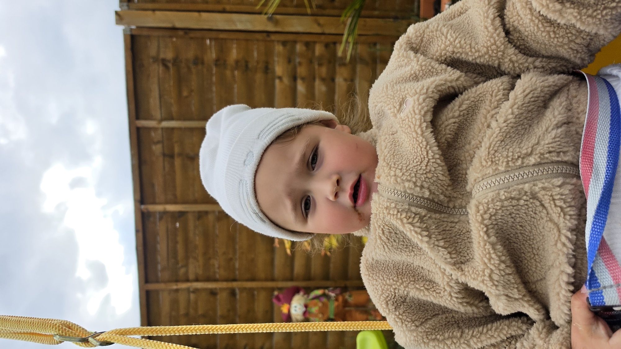 Toddler spotted in London wearing winter clothing and harness
