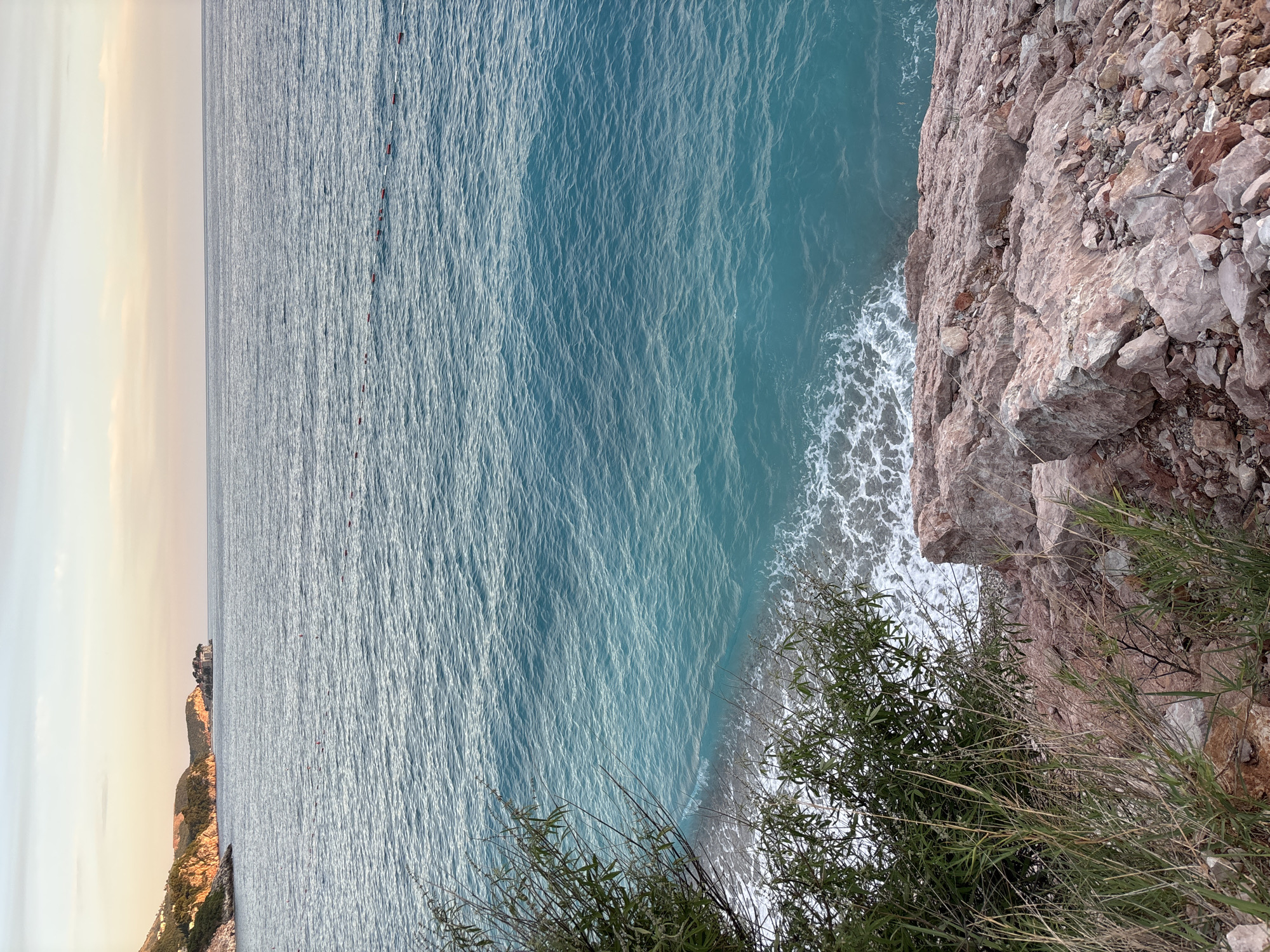 Sunset along the wildflower-lined rocky coast of Kamenovo