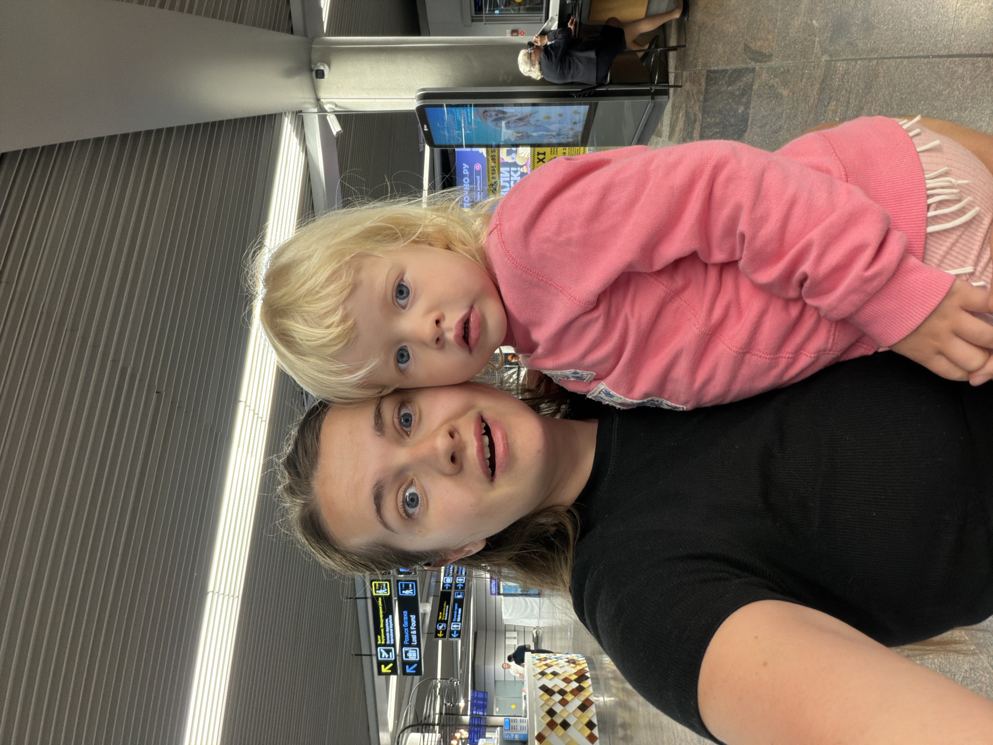Family with toddler navigates Sochi Airport during overnight hours