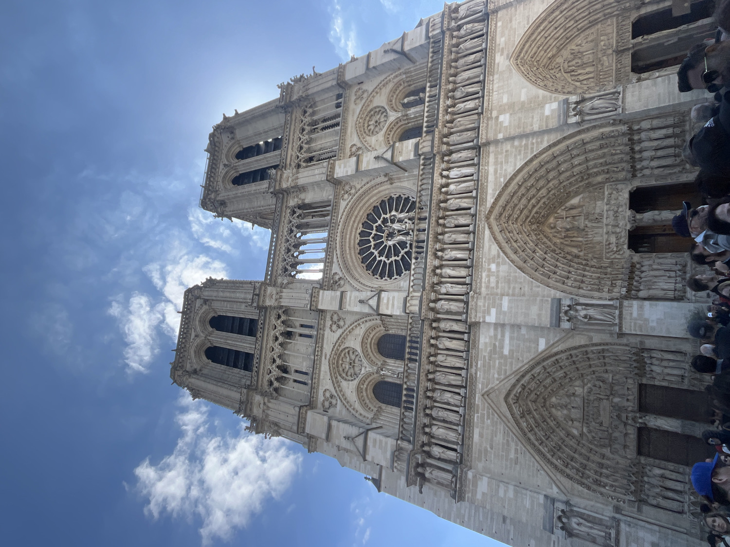 Tourist photographs Notre Dame Cathedral and Seine River in Paris