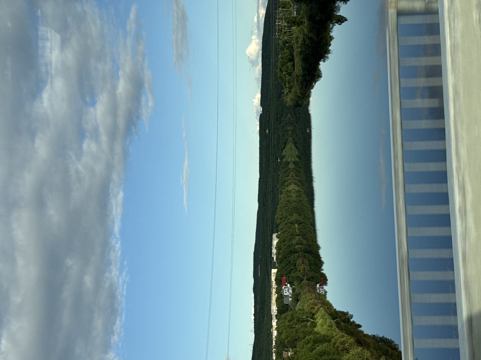 Driving through Zverosovkhoz along a calm Russian riverside