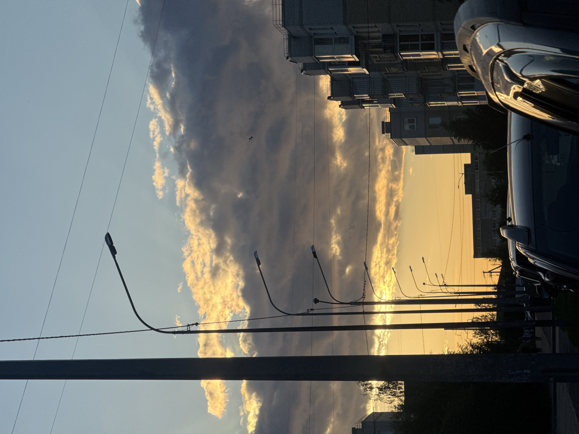 Sunset clouds over Shushary streets, golden light and silhouettes